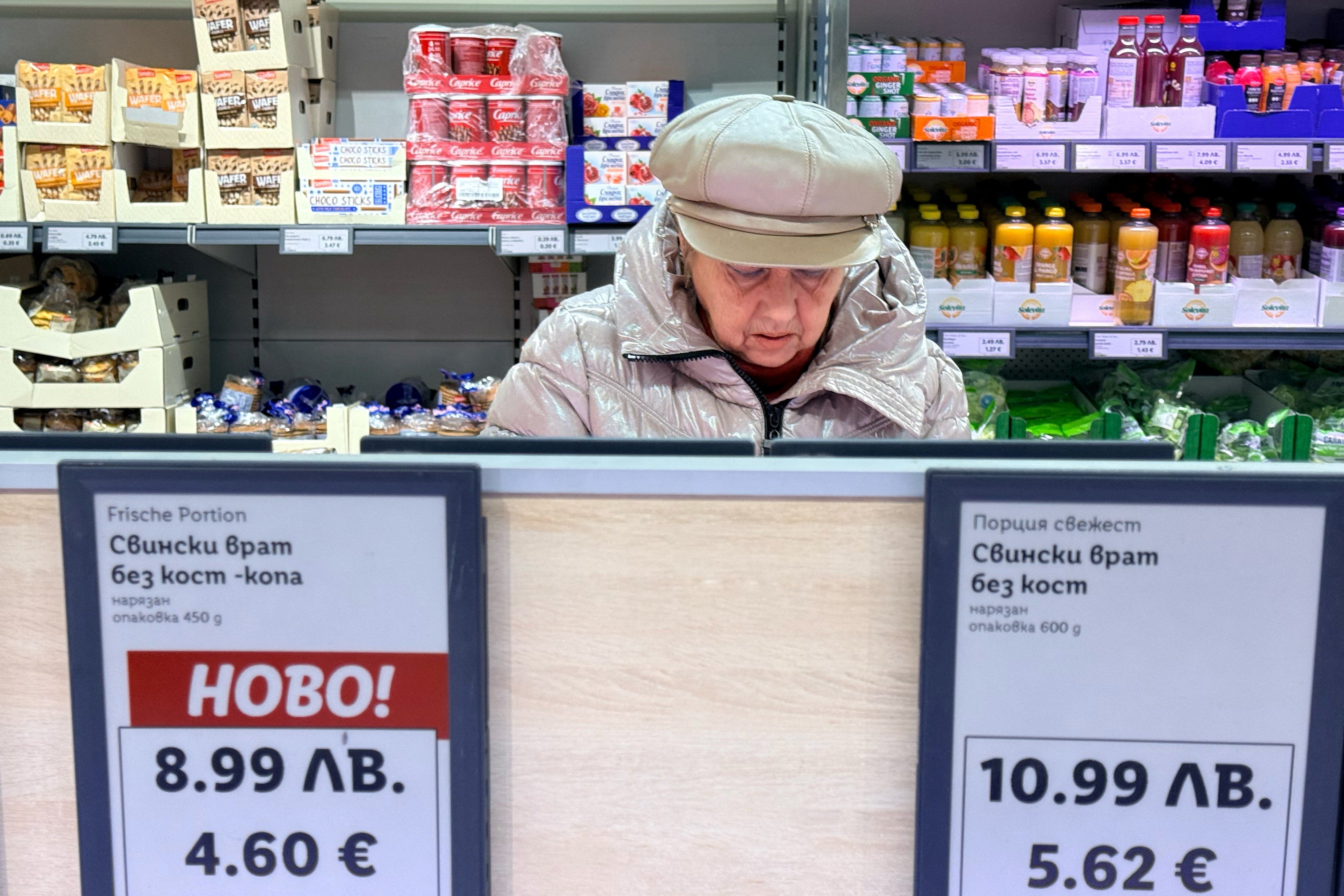 A woman shops inside a Lidl store in Sofia where prices are already displayed in both currencies