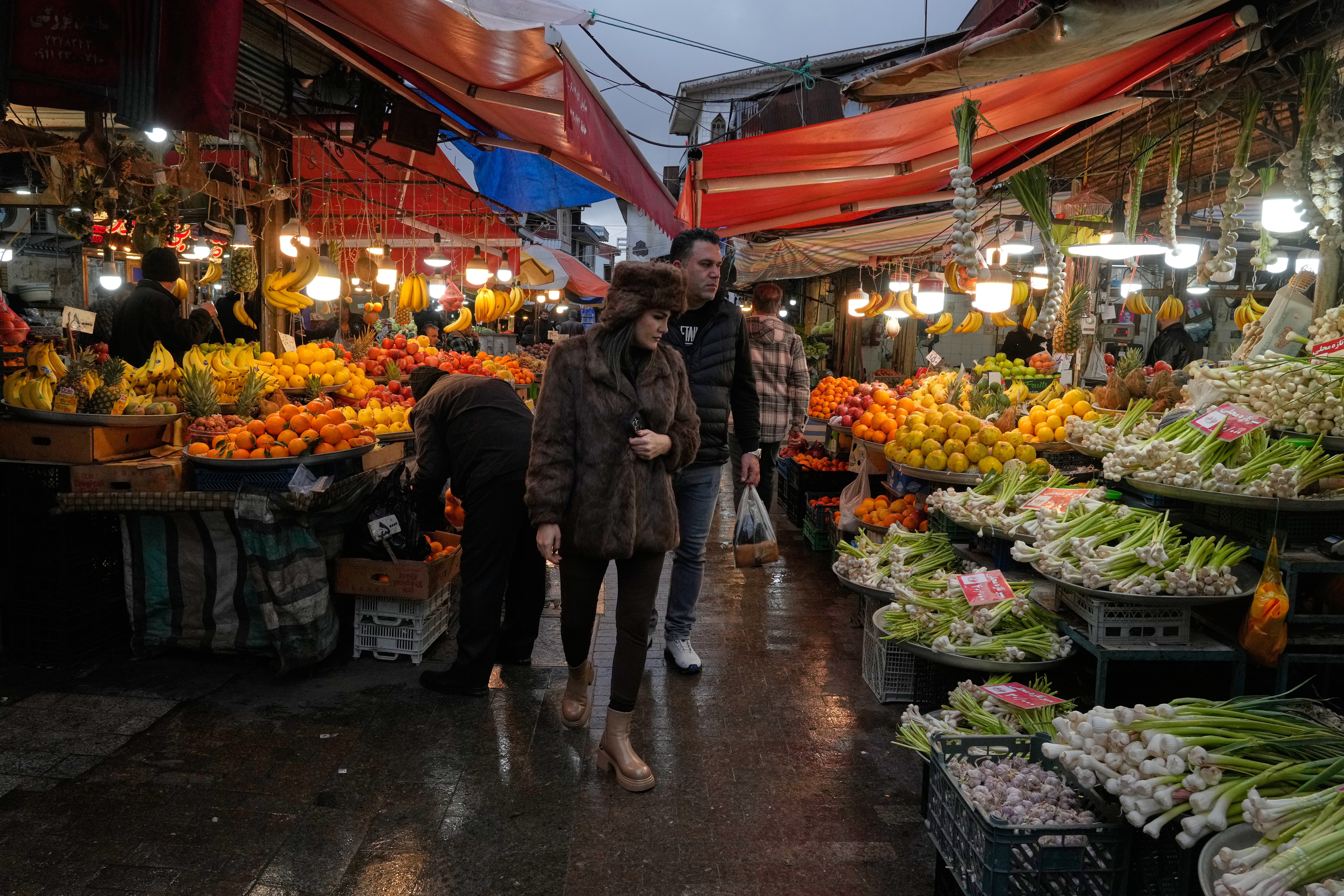 People shop in the old main bazaar of the northern city of Rasht, Iran, on Friday, Dec. 26, 2025. (AP Photo/Vahid Salemi)