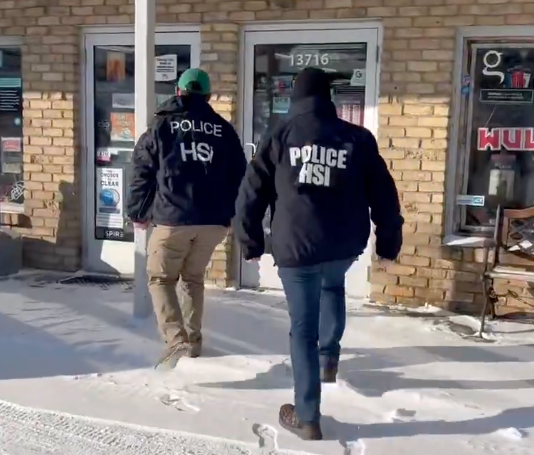 Two Homeland Security Investigations agents conduct inquiries at a small business in Burnsville, Minnesota, Monday in response to a viral video alleging widespread fraud in the state that has incensed conservatives