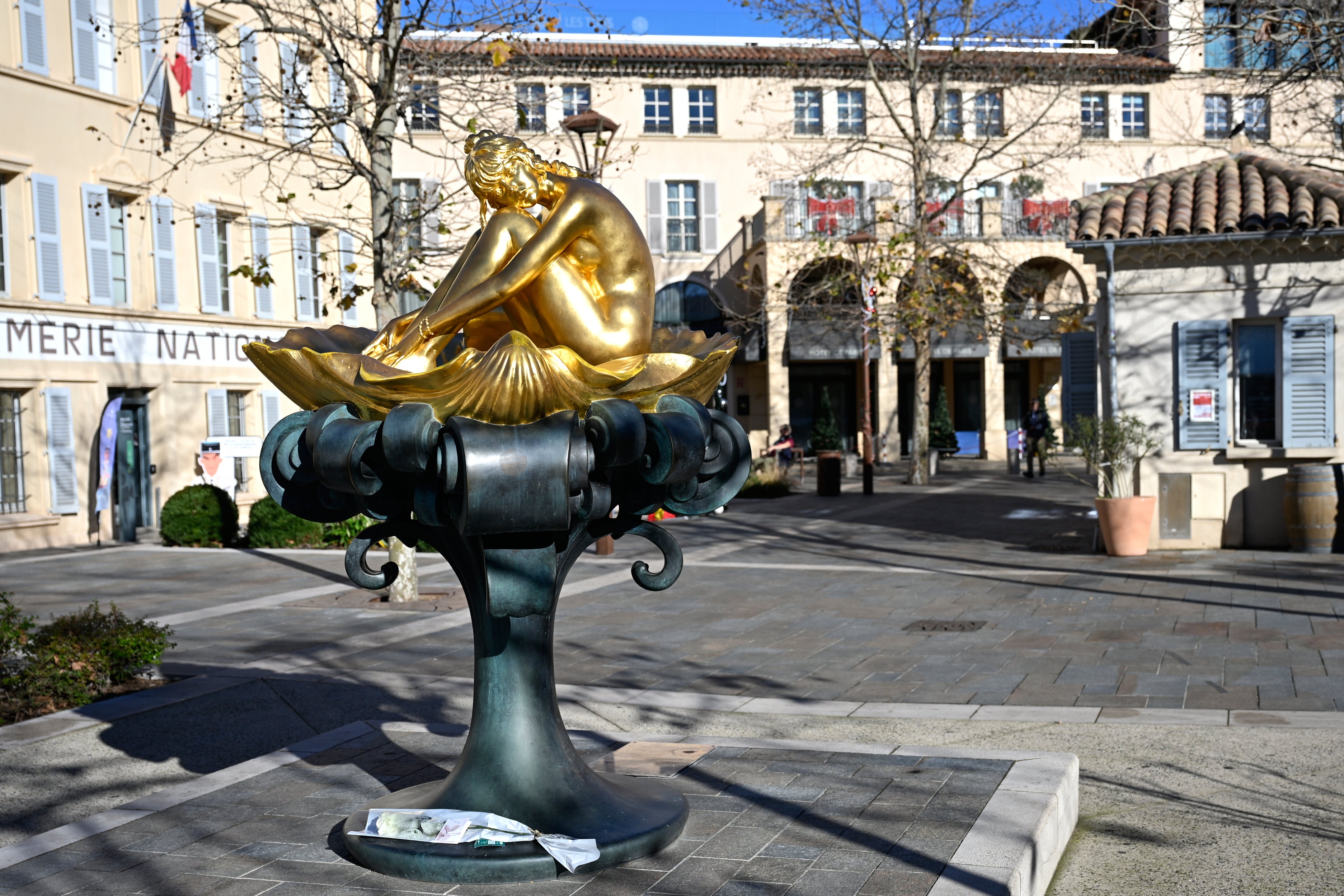 A flower lays by a statue representing actor Brigitte Bardot in Saint-Tropez
