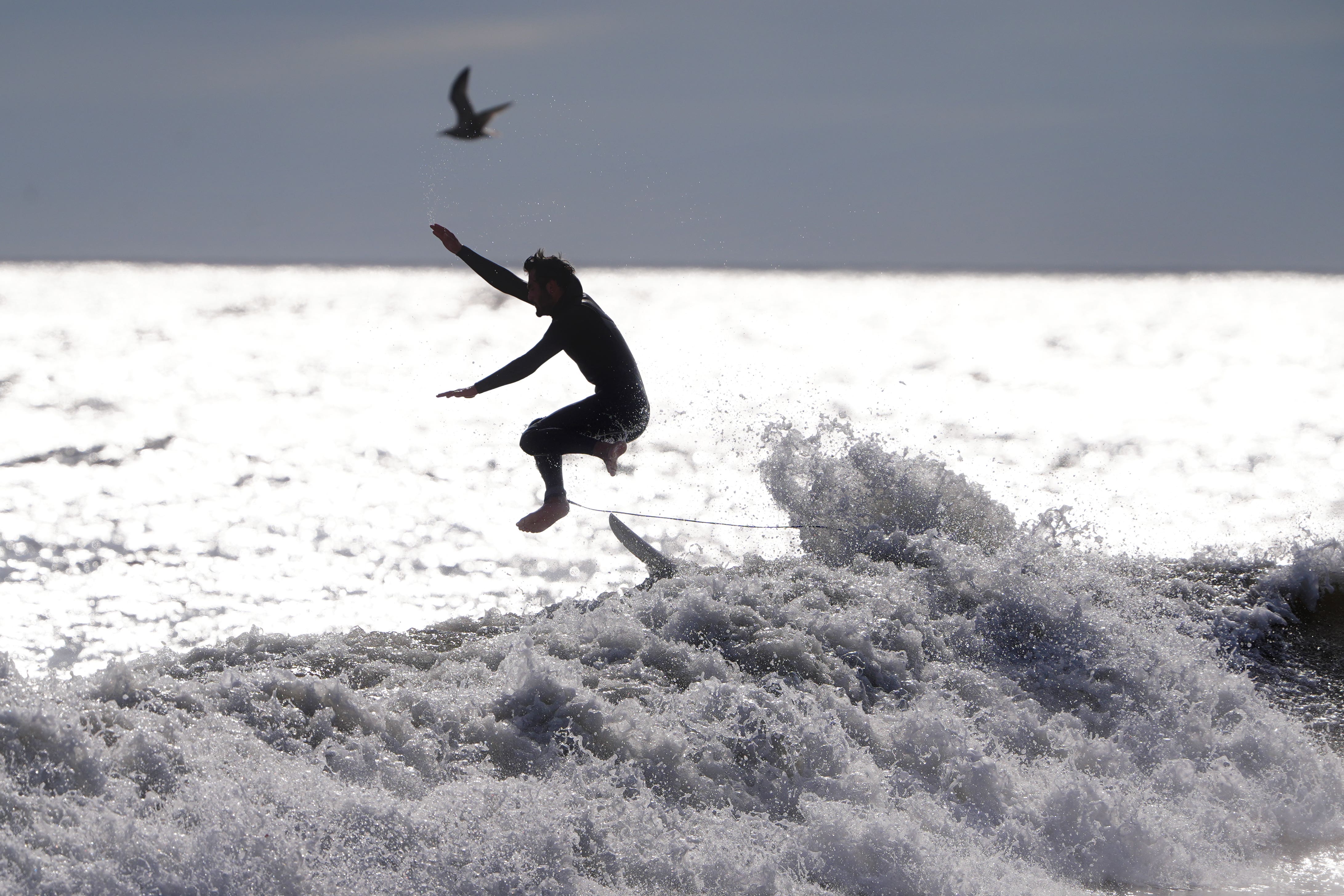 A surfer at Tynemouth Longsands beach (Owen Humphreys/PA)