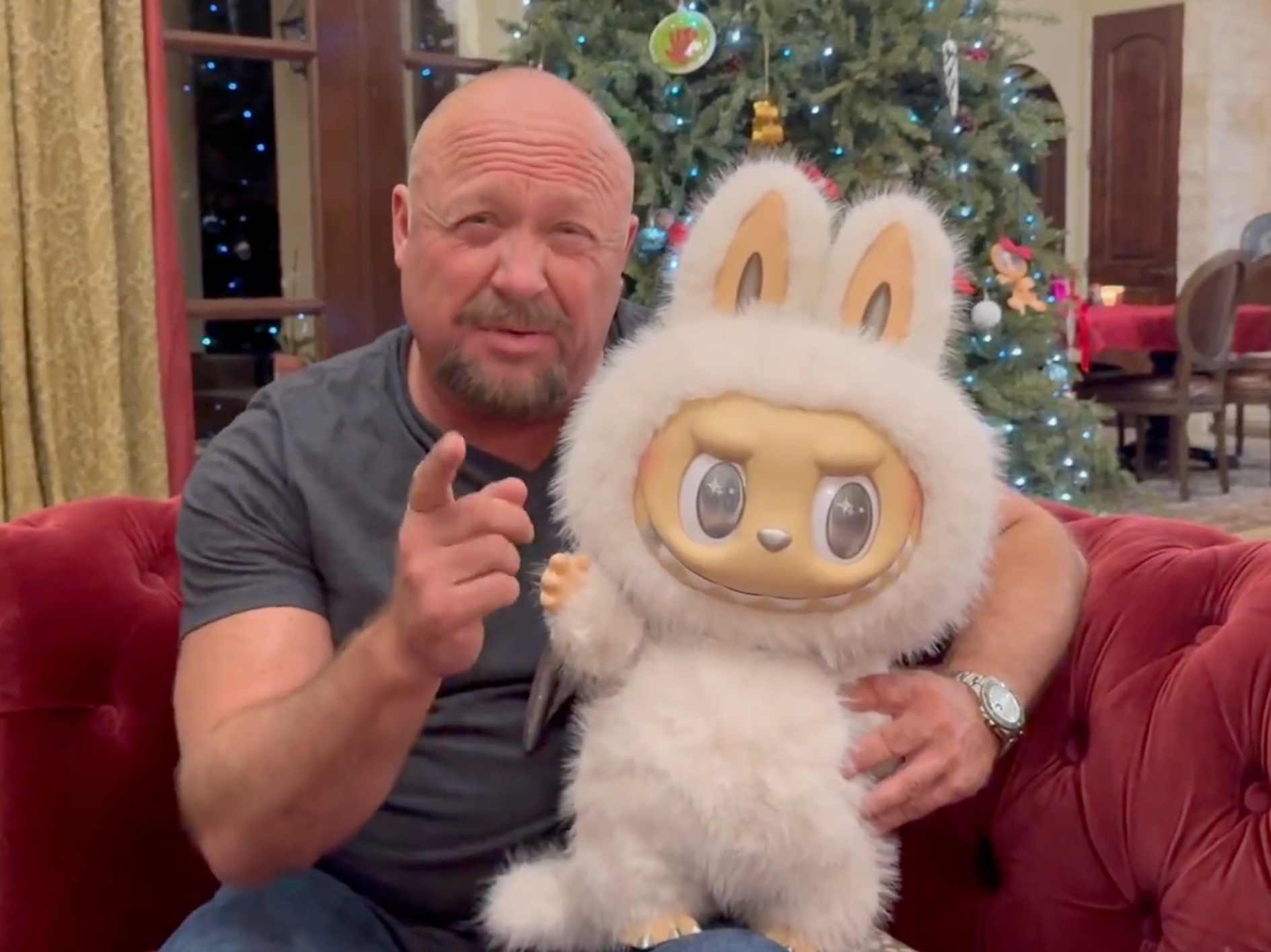 Alex Jones poses with a Labubu in a Christmas video for his followers on X, rather than address the Epstein files