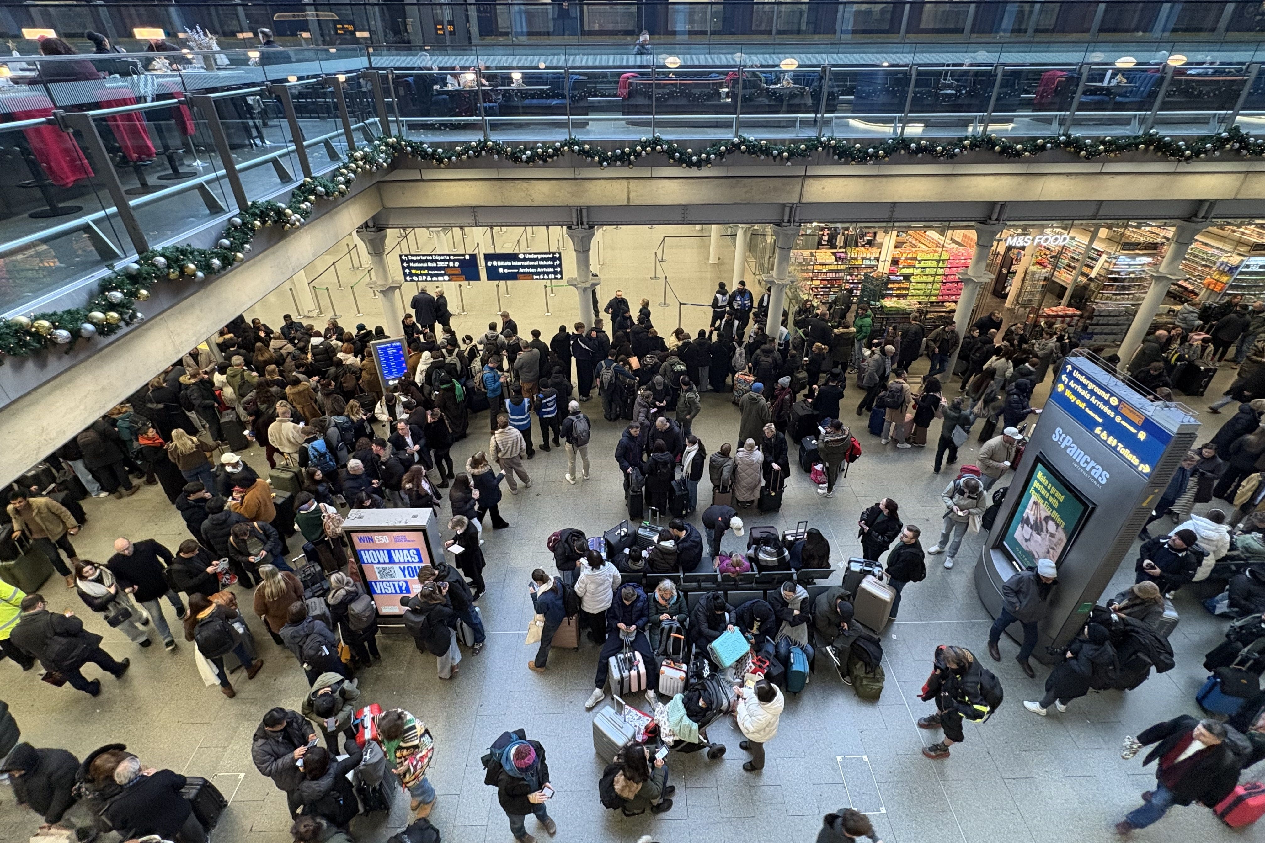 Delayed passengers at St Pancras train station, central London, after all Eurostar services were cancelled (Jonathan Brady/PA)