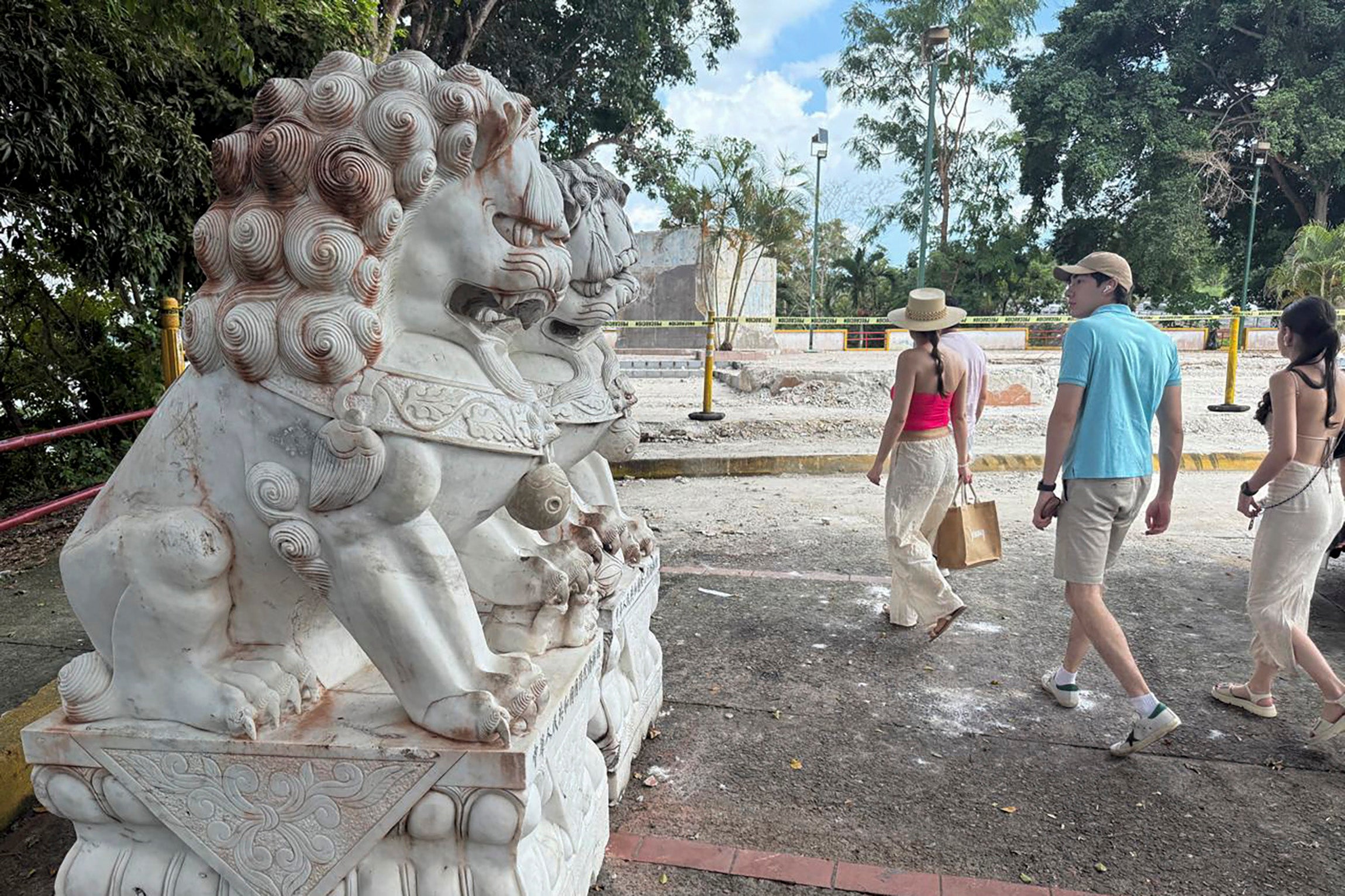 People walk near where a Chinese monument stood before it was demolished in Arraijan, Panama
