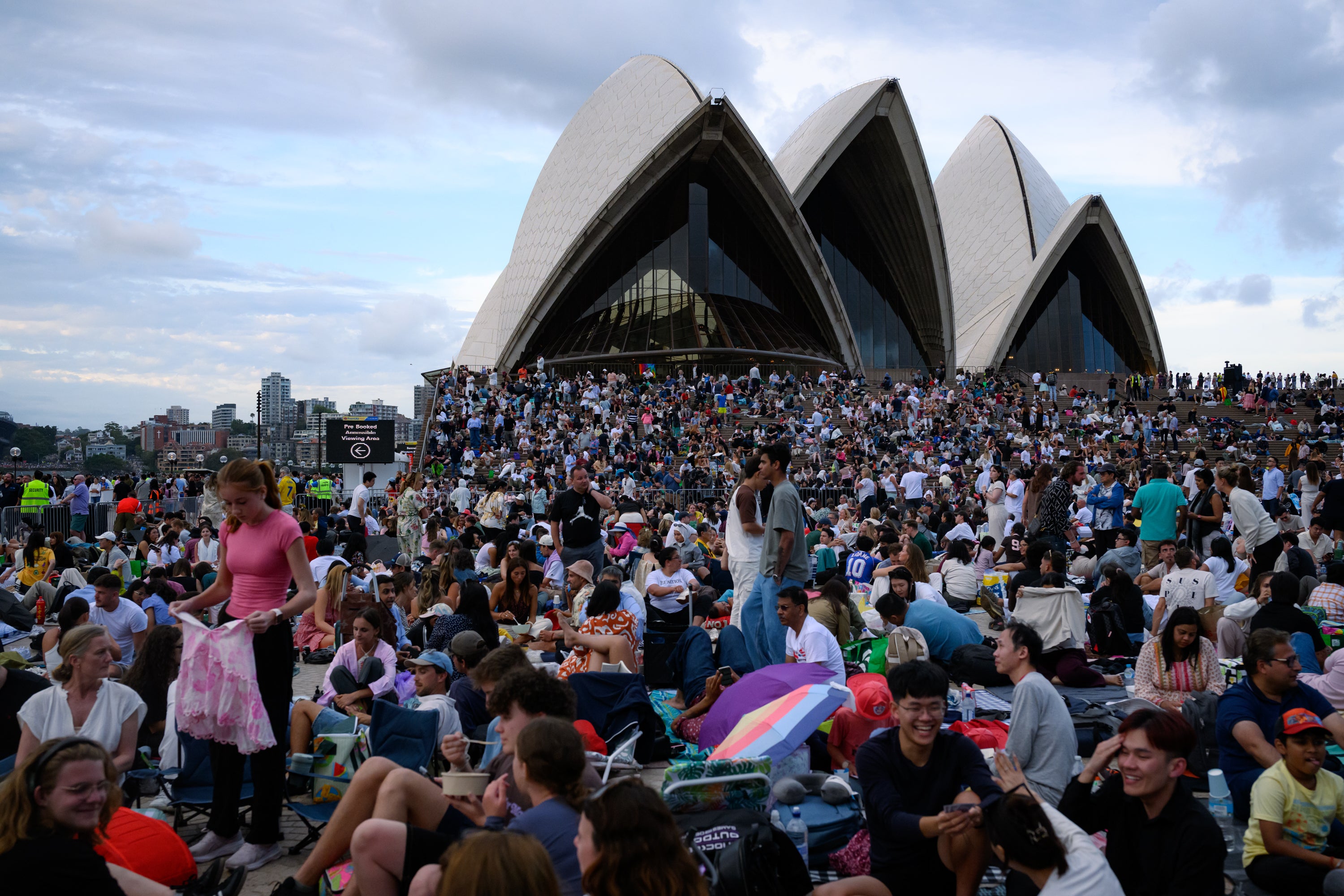 People gather at the Sydney Opera House in anticipation of the annual New Year’s Eve fireworks display