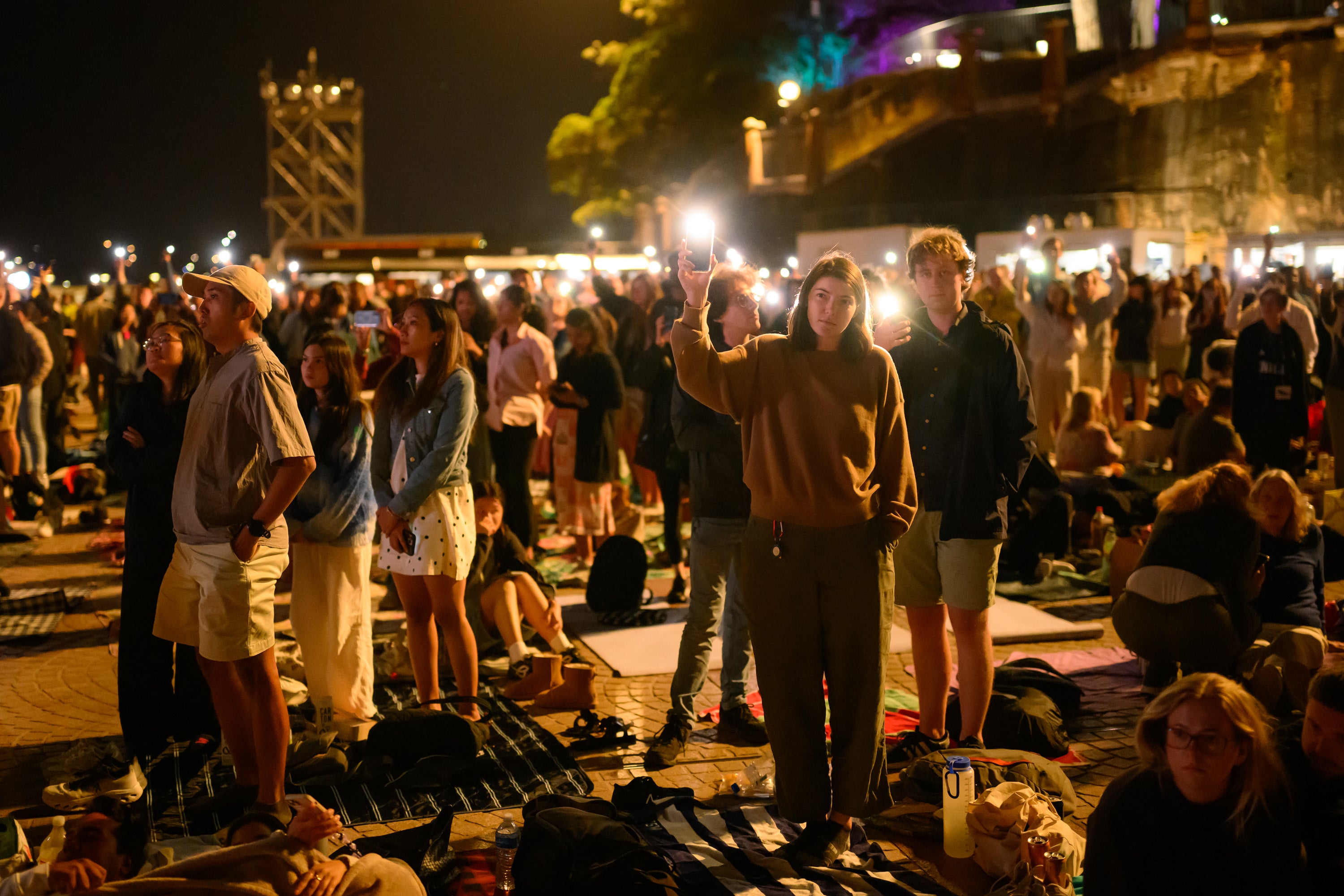 People turn on their phone flashlights to honour the victims of the Bondi shooting near the Opera House in Sydney on 31 December 2025