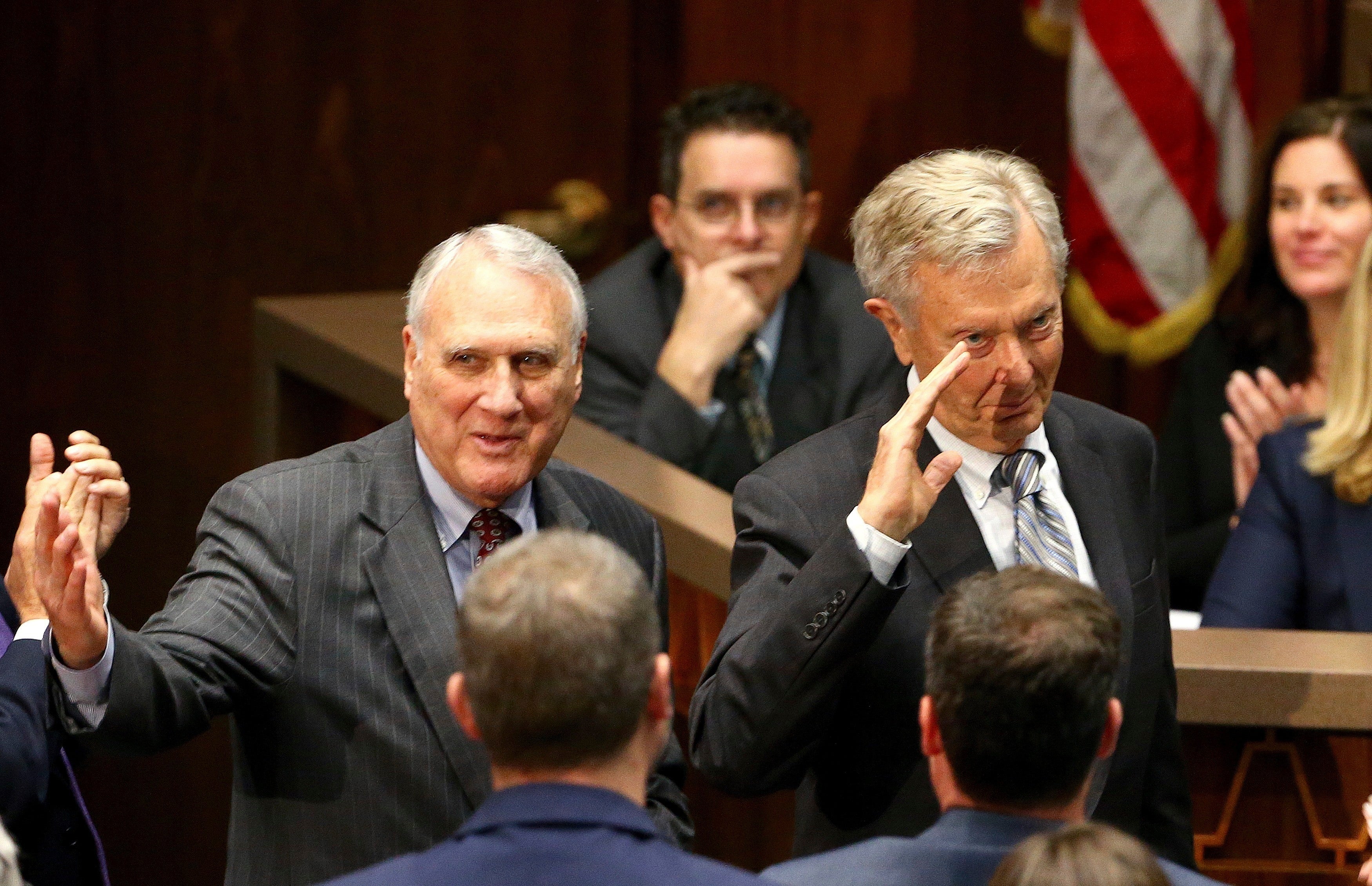 Sen. Jon Kyl, left, and Bruce Babbitt, right, former Arizona Republican governor and secretary of the Interior, wave to the crowd as they are recognized during Arizona Gov. Doug Ducey's state of the state address Monday, Jan. 14, 2019, in Phoenix
