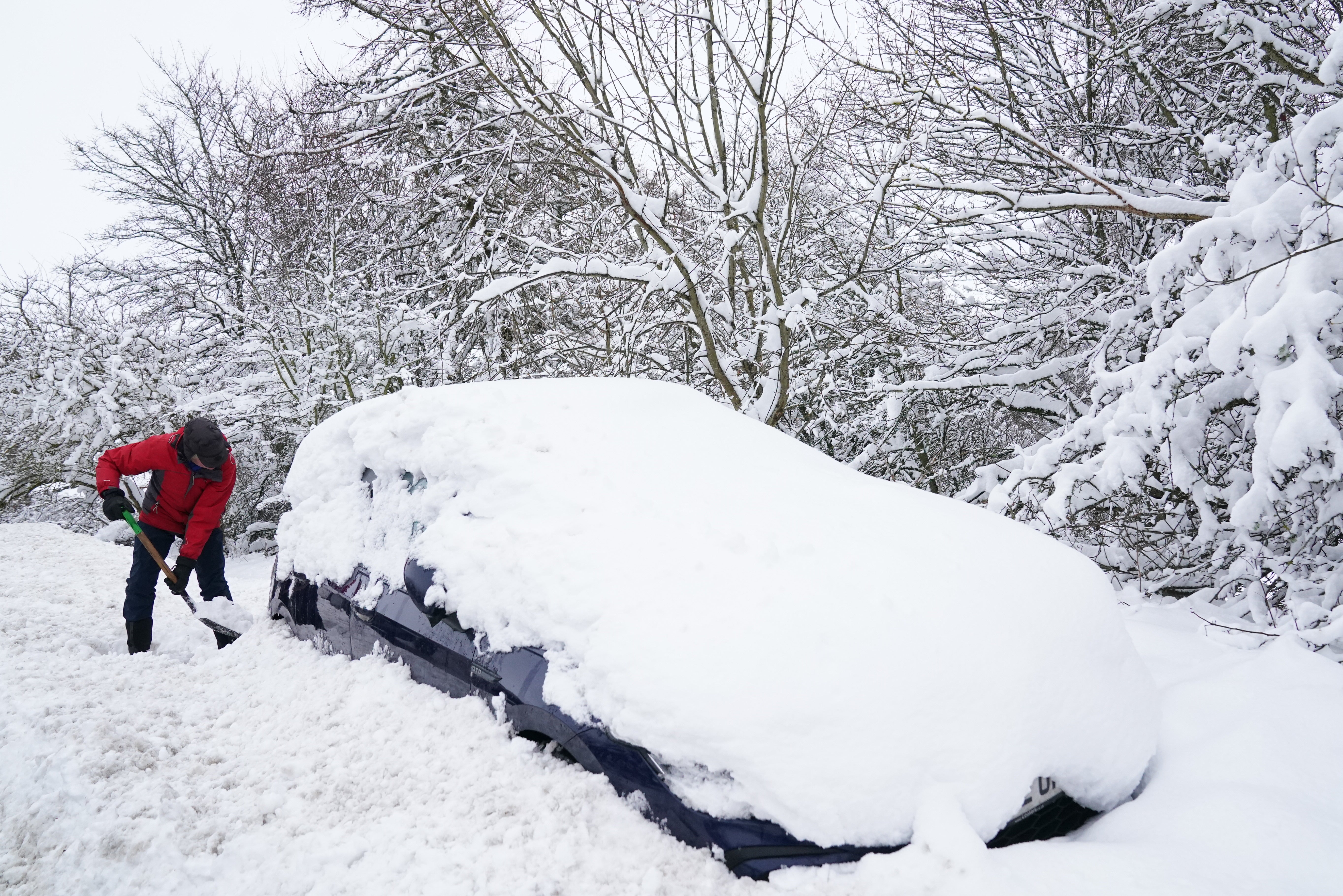 A man digs a car out of the snow in Northumberland last year