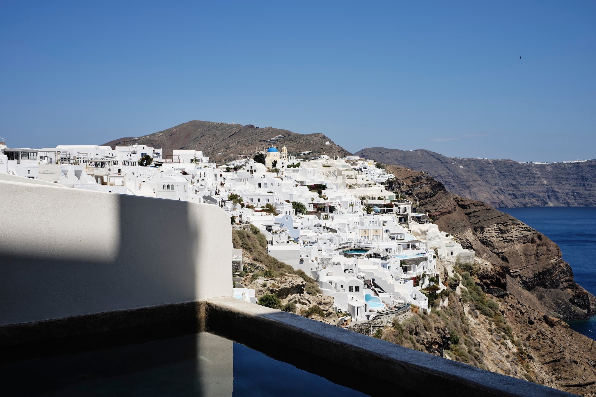 The hotel offers uninterrupted views above Oia