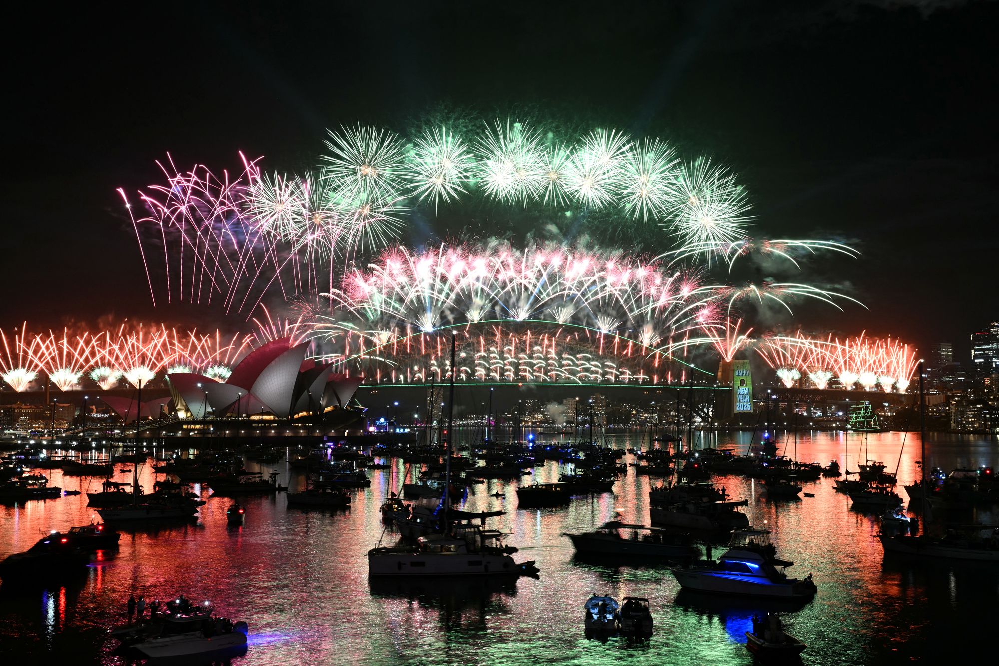 Fireworks light up the midnight sky over Sydney Harbour Bridge and Sydney Opera House during New Year’s celebrations