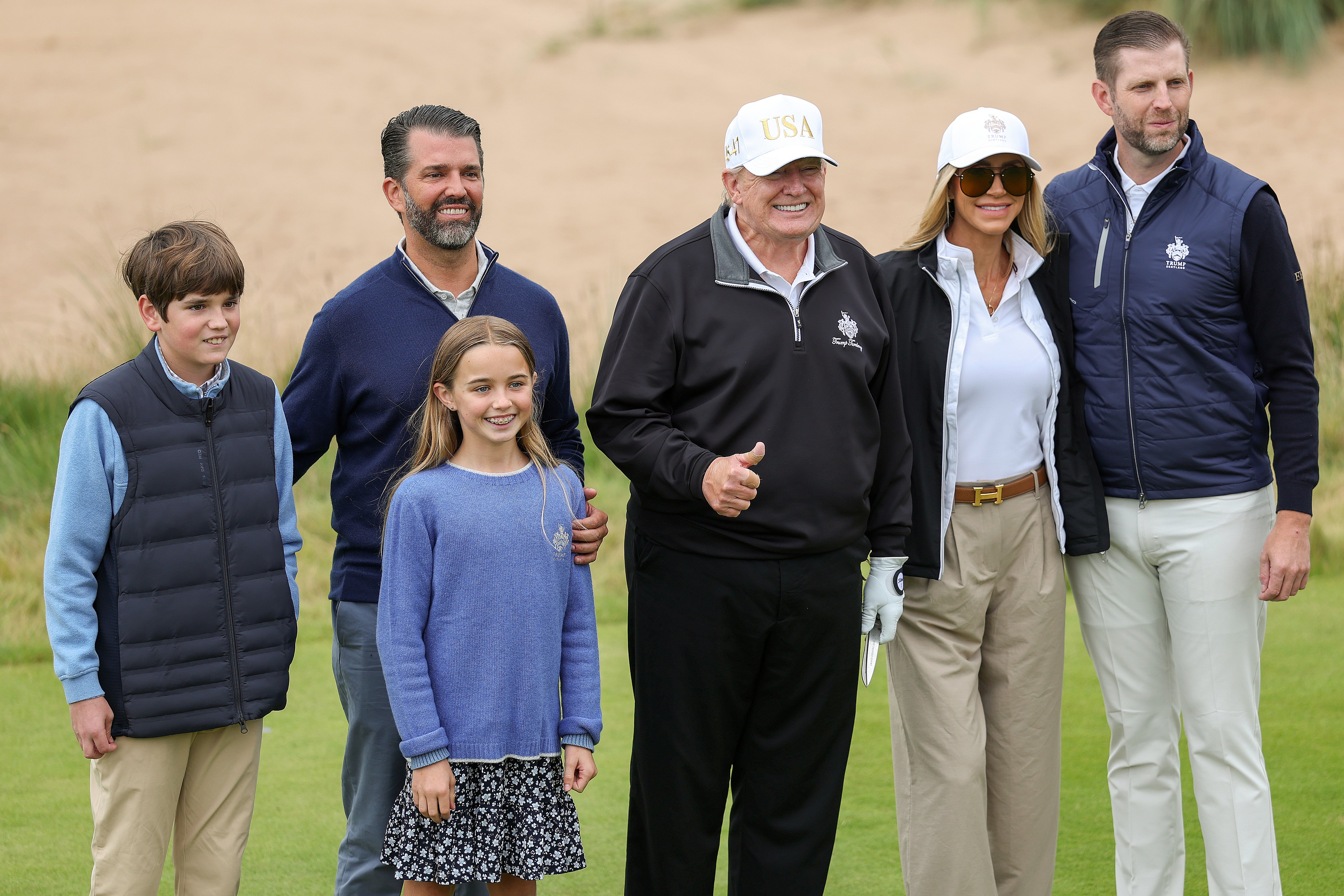 Keeping it in the family : President Donald Trump stands with Donald Trump Jr. (2nd L), Lara Trump (2nd R) and Eric Trump and family at the ribbon-cutting ceremony at a new 18-hole course at Trump International Golf Link