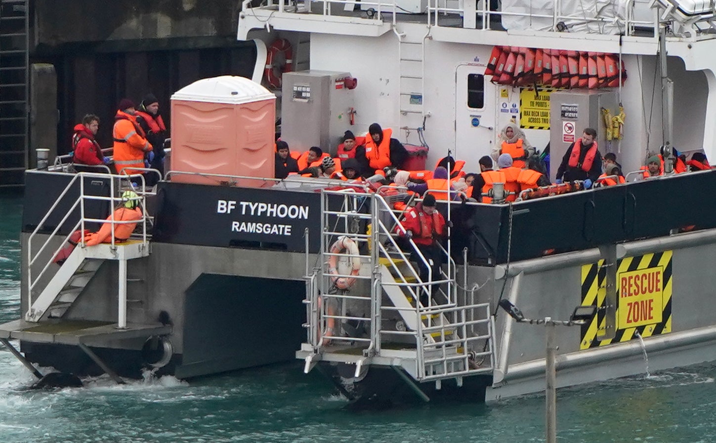 A group of people thought to be migrants are brought into the Border Force compound in Dover, Kent, on 20 December