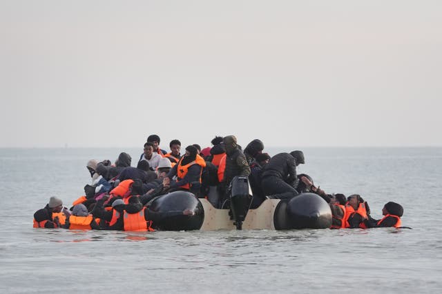 <p>People thought to be migrants scramble onboard a small boat leaving the beach at Gravelines, France, in an attempt to reach the UK by crossing the English Channel</p>