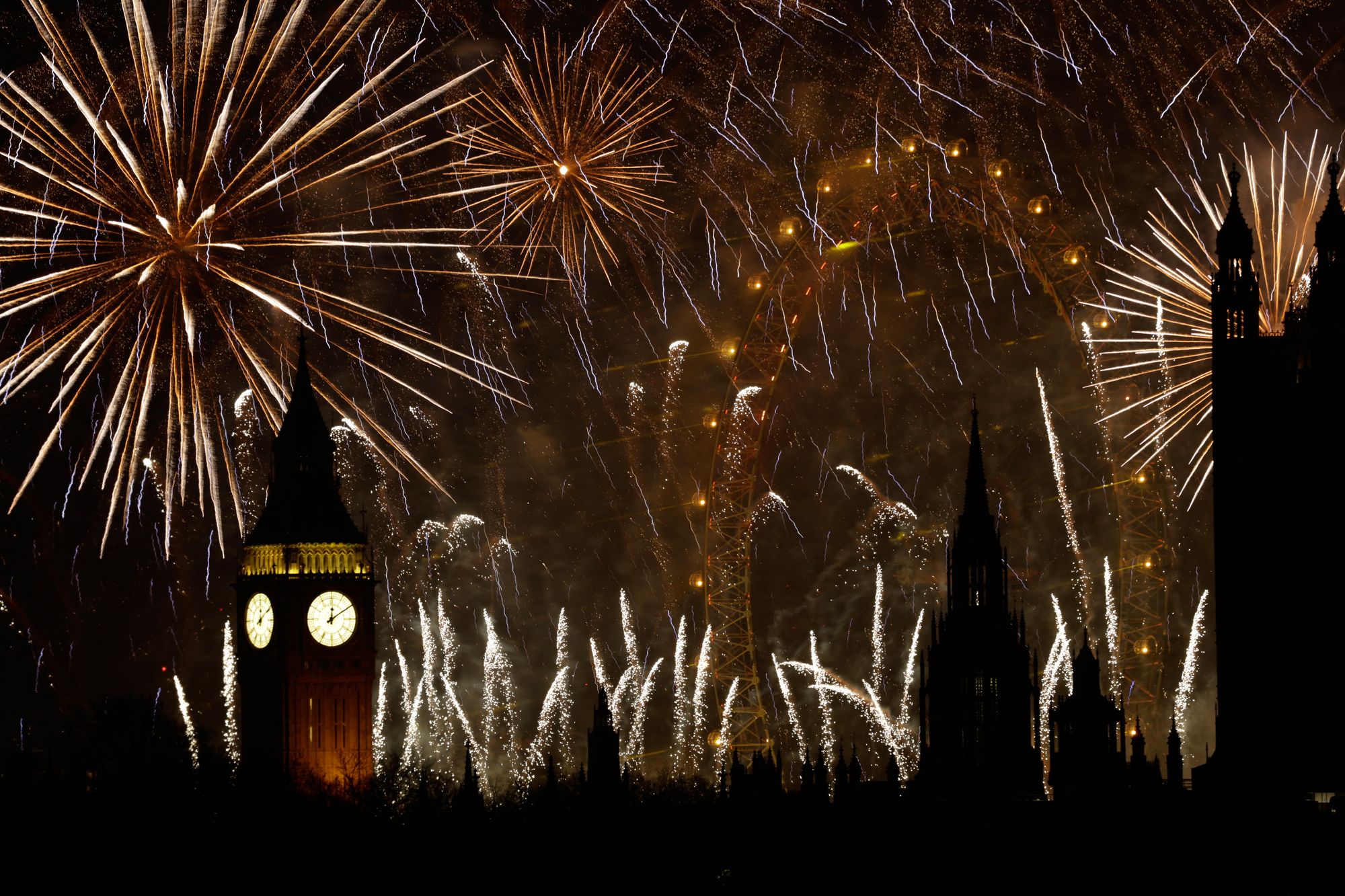 Fireworks explode in the sky to bring in the New Year around the London Eye and the Elizabeth Tower