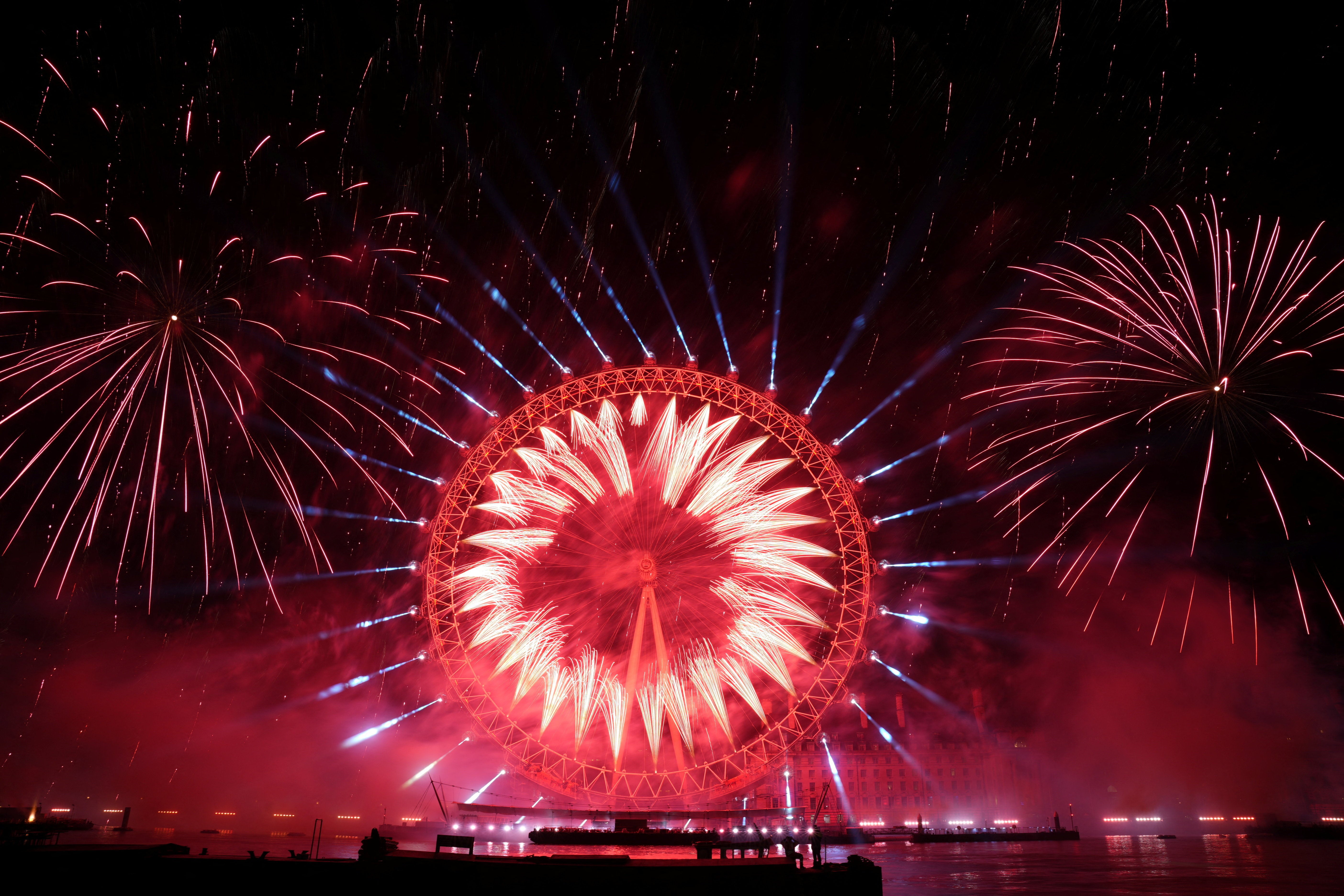 Fireworks explode near the London Eye Ferris wheel to mark the New Year's celebrations, in London