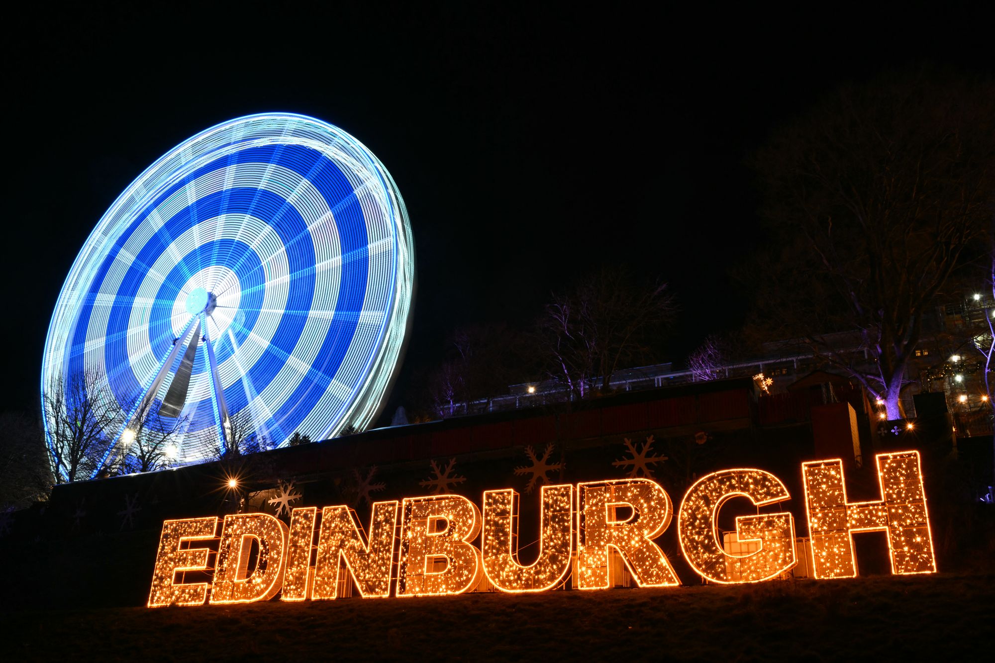 A general view shows signage and the 'Big Wheel' at Princes Street Gardens in Edinburgh