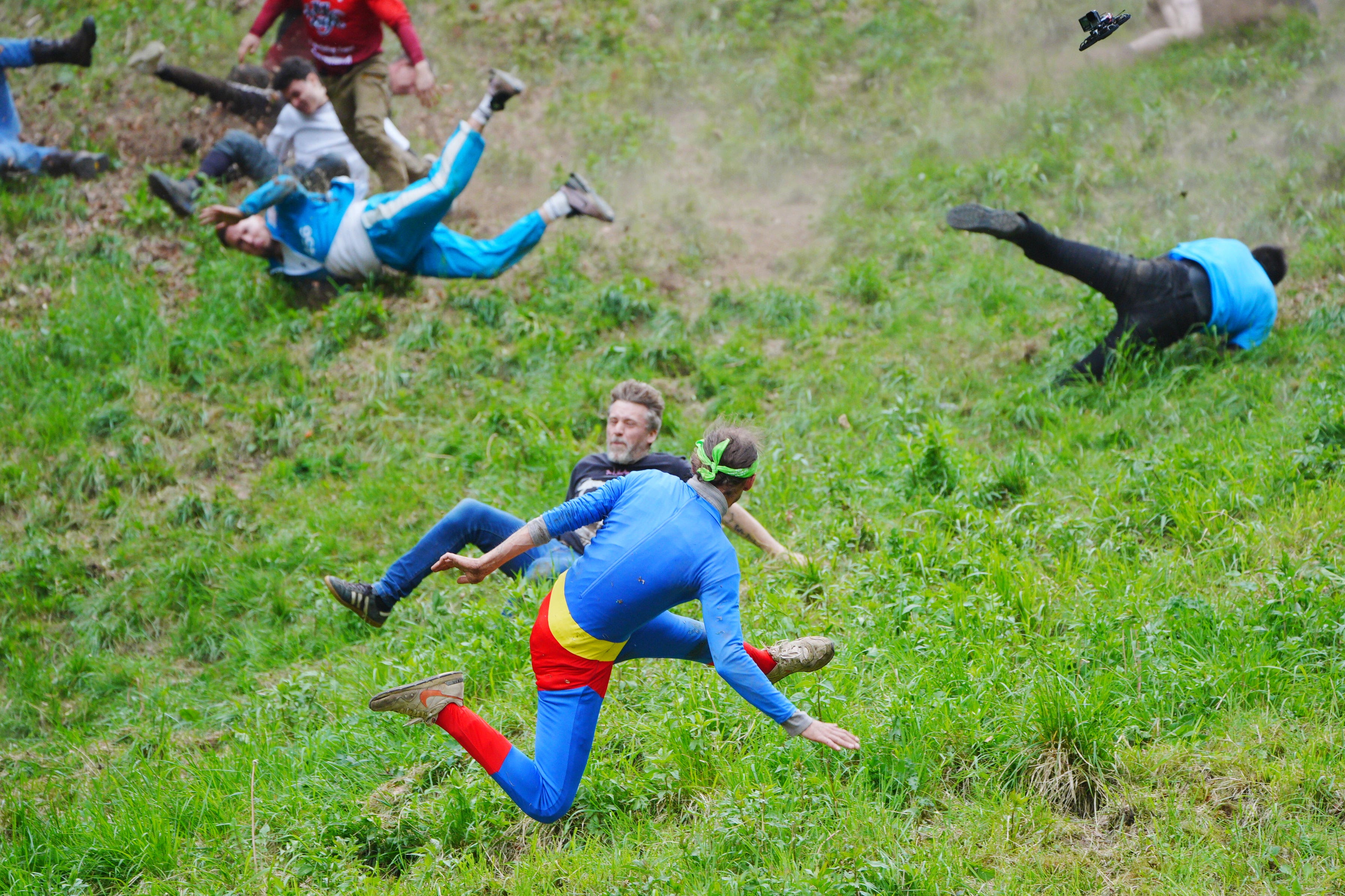 Participants take part in the annual cheese rolling at Cooper’s Hill in Brockworth, Gloucestershire (Ben Birchall/PA)