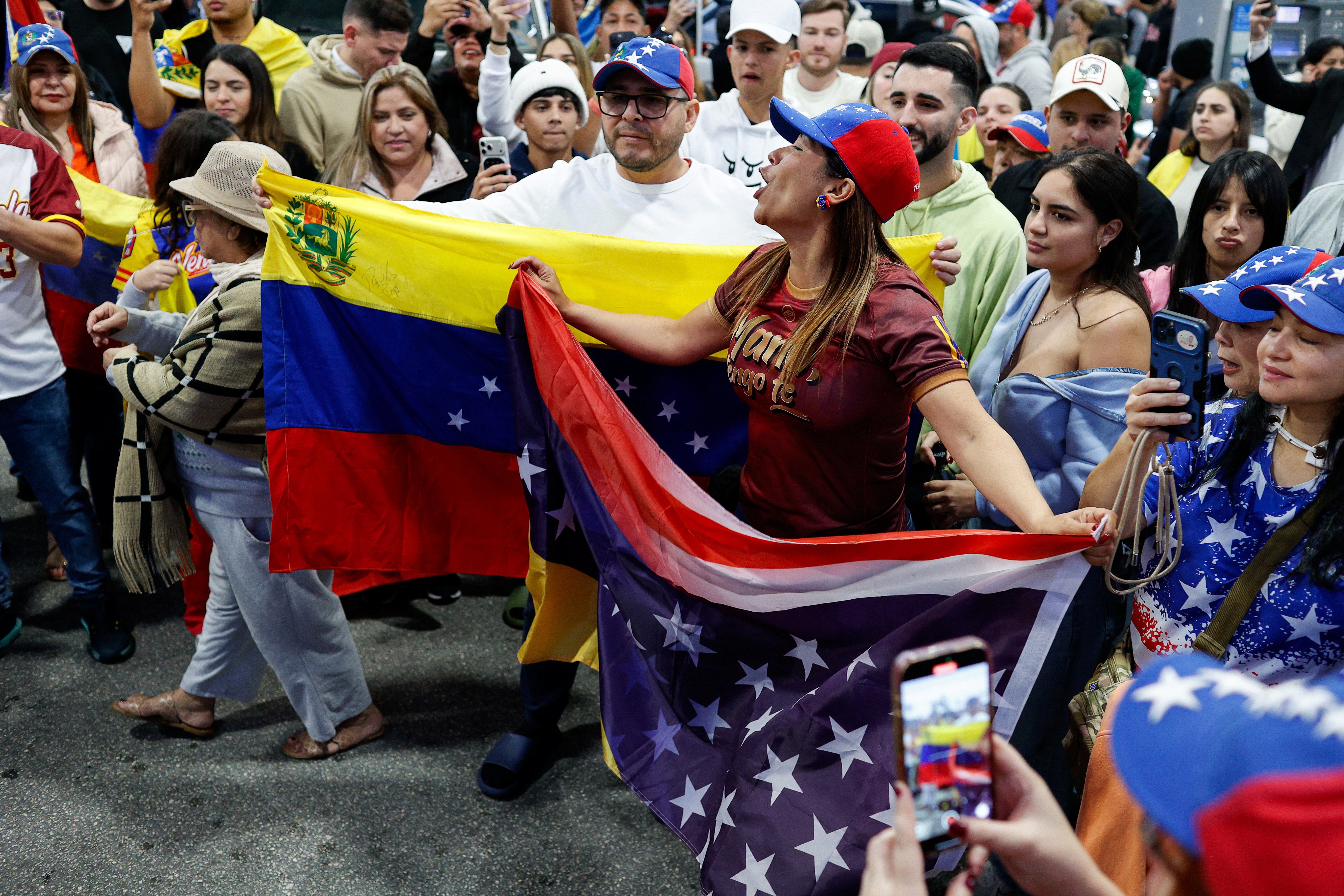 In Florida, home to the largest Venezuelan community in the United States, people wrapped themselves in Venezuelan flags, ate fried snacks and cheered as music played