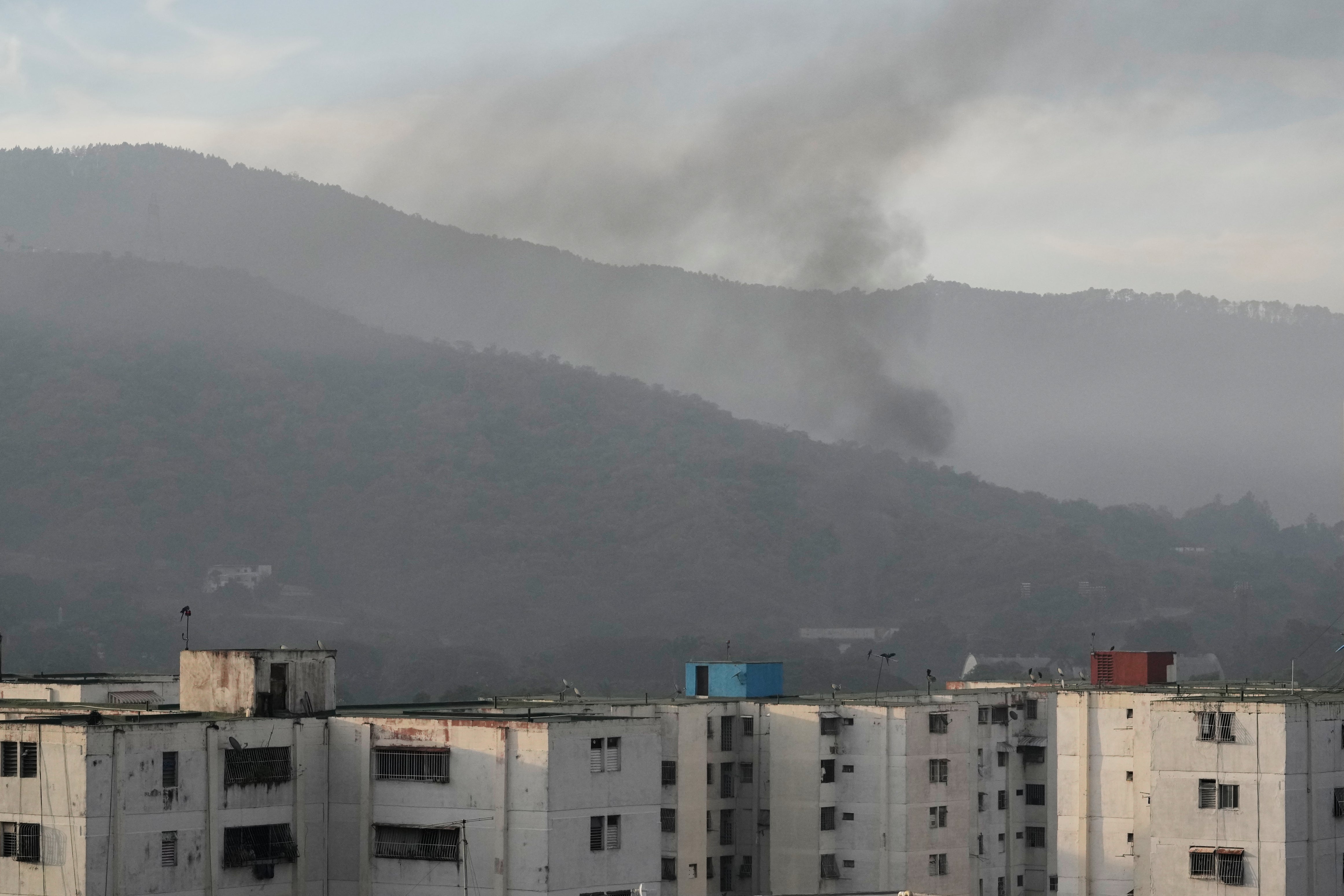 Smoke rises from Fort Tiuna, the main military garrison in Caracas, Venezuela, after multiple explosions were heard and aircraft swept through the area, Saturday, Jan. 3, 2026. (AP Photo/Matias Delacroix)