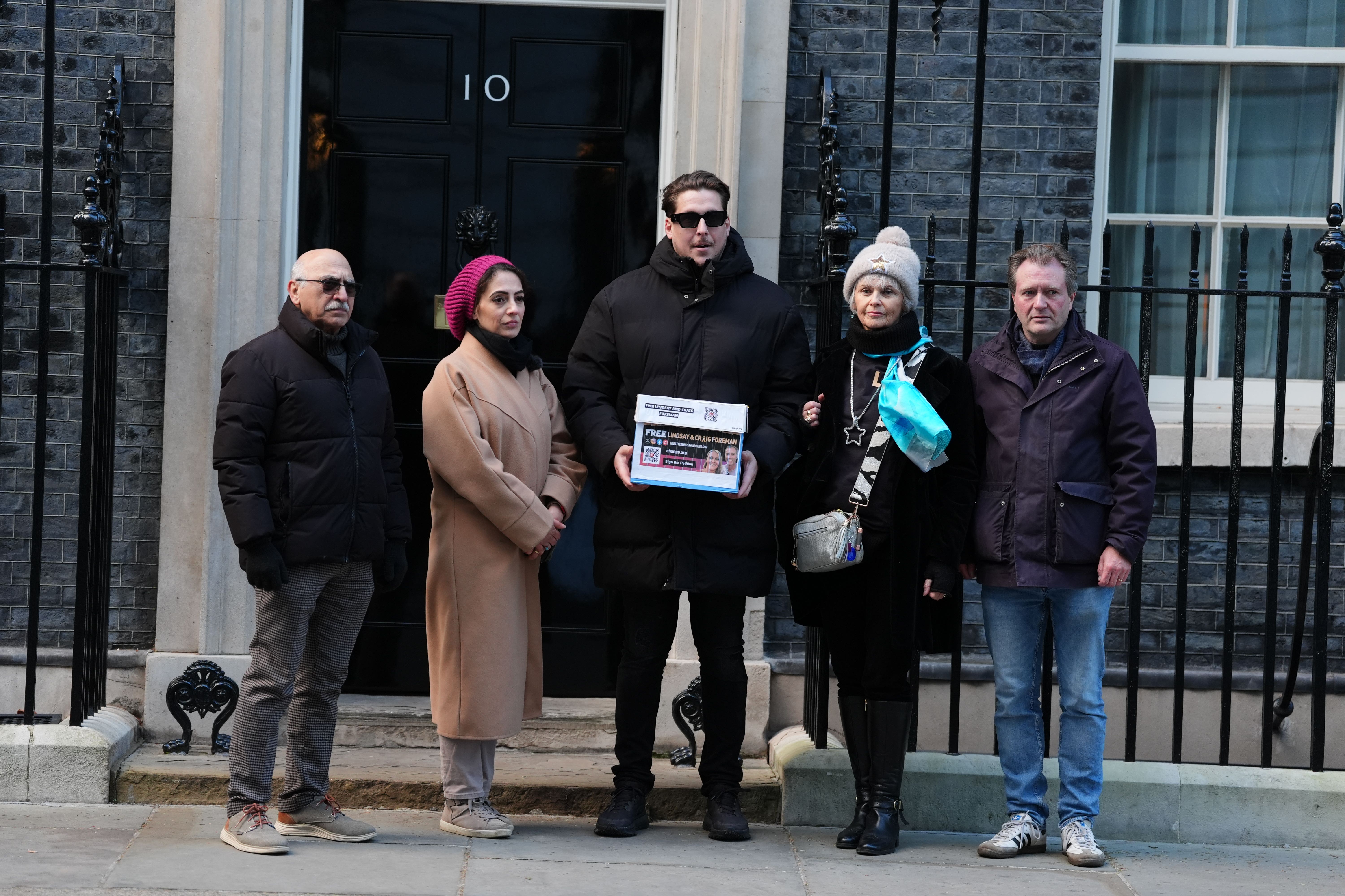 (Left to right) Anoosheh Ashoori, his daughter Elika Ashoori, Joe Bennett, Sue Clarke and Richard Ratcliffe hand in a petition to Number 10 Downing Street, London, on the one year anniversary of Lindsay and Craig Foreman’s detention in Iran (Ben Whitley/PA)