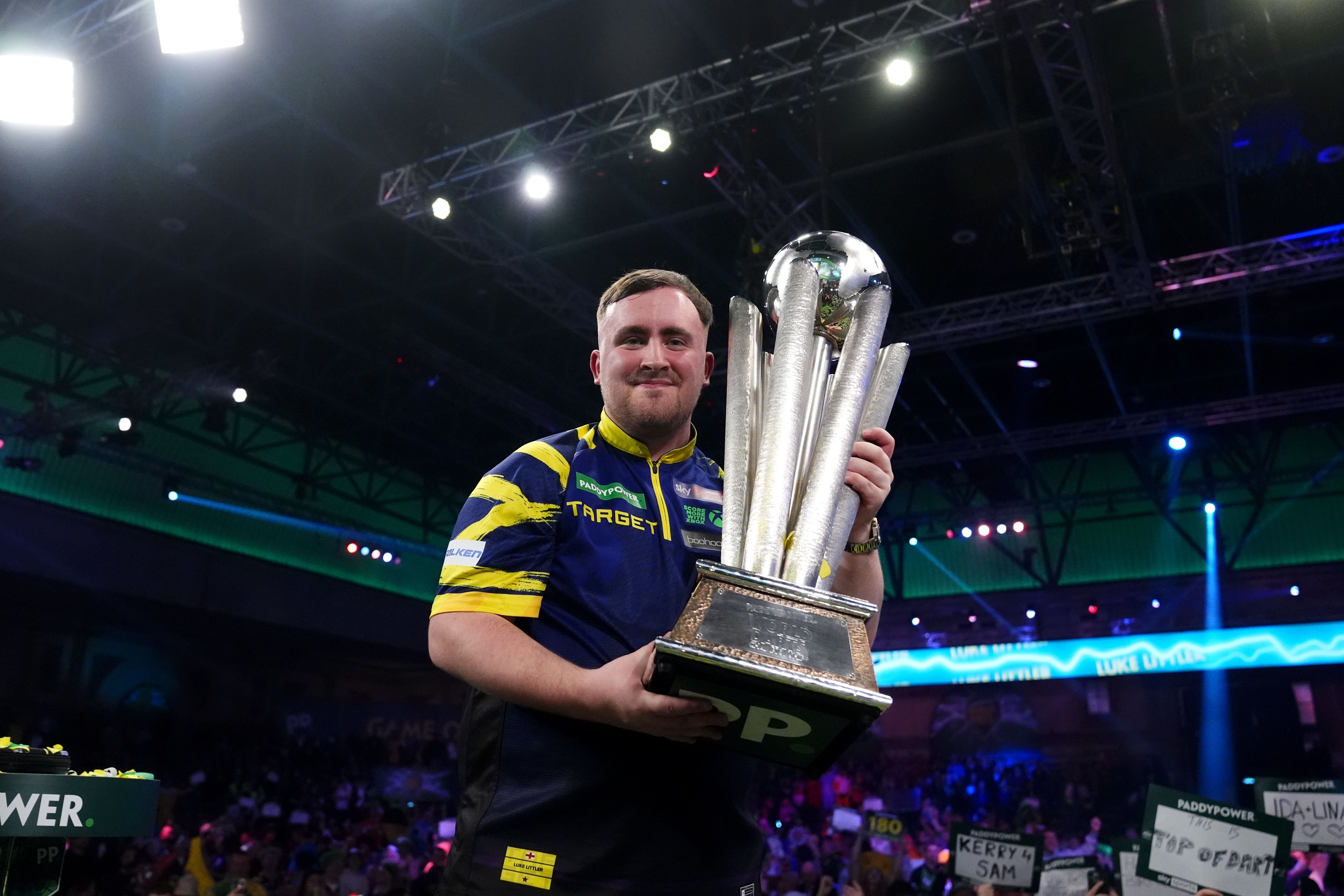 Luke Littler celebrates with the Sid Waddell trophy after victory against Gian van Veen in the final of the World Darts Championship at Alexandra Palace (John Walton/PA)