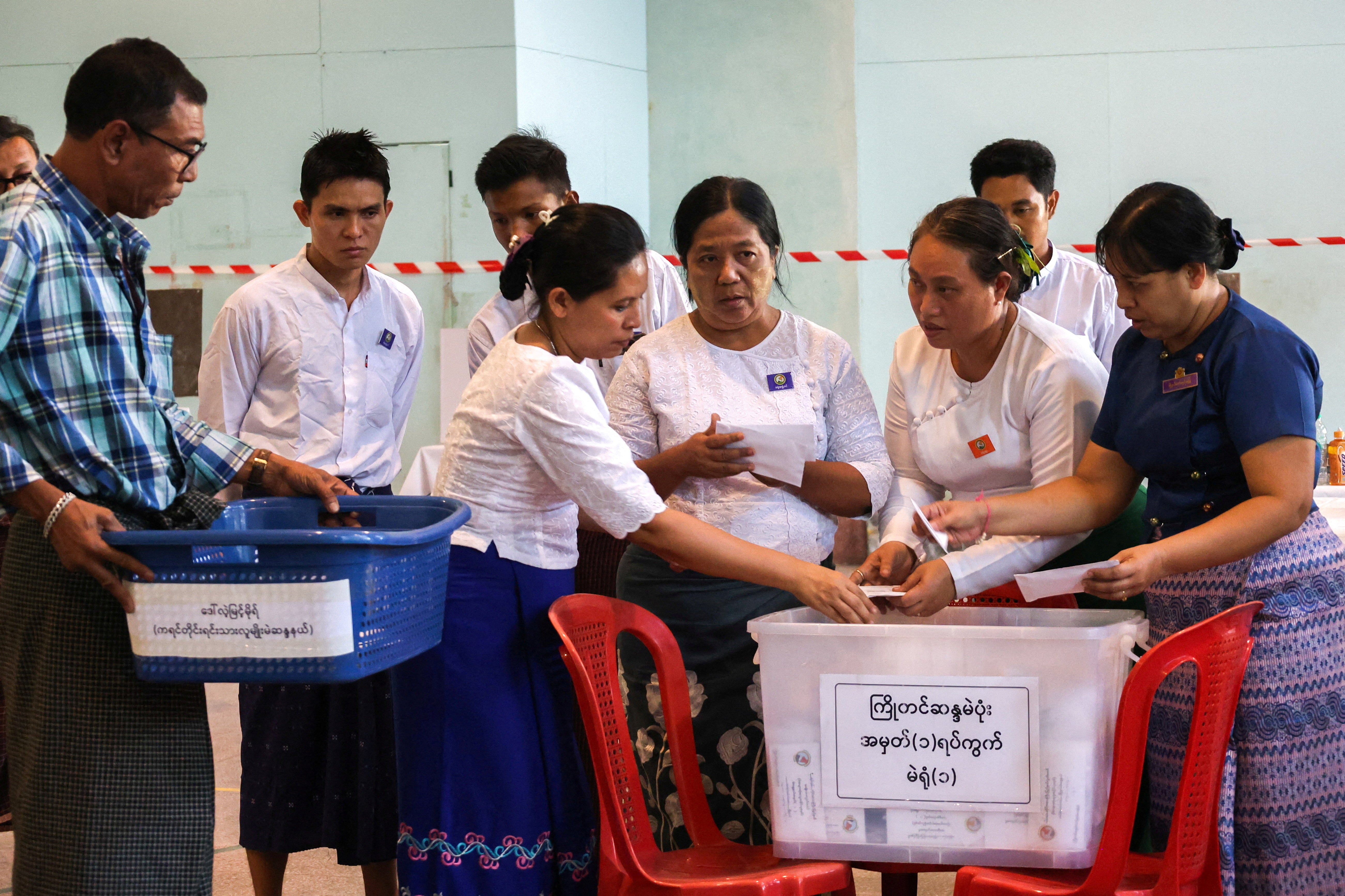 Election Commission officials count ballots at a polling station during Myanmar's general election in Yangon, Myanmar, 28 December 2025