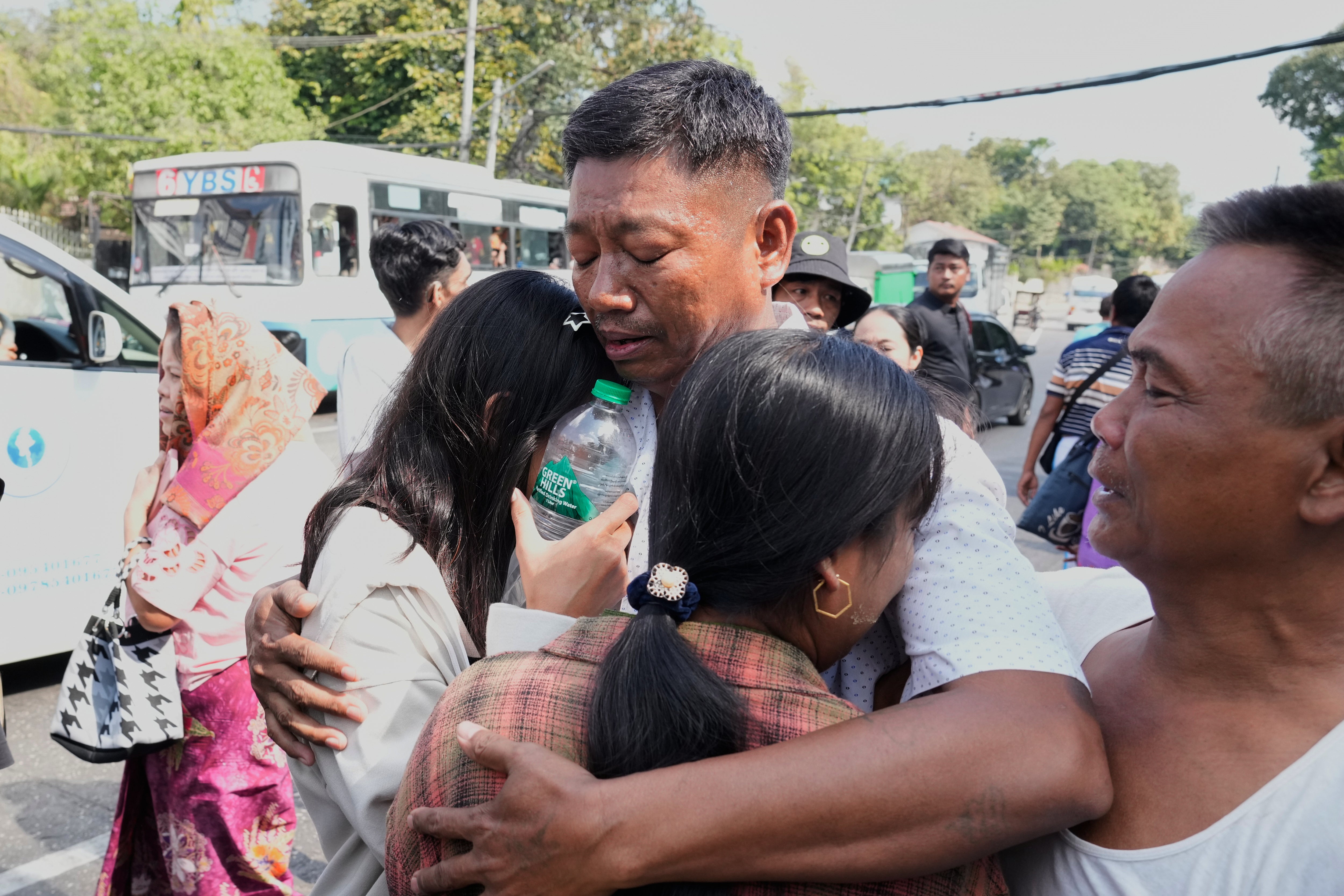 A prisoner is greeted by his family members after being released from Insein prison