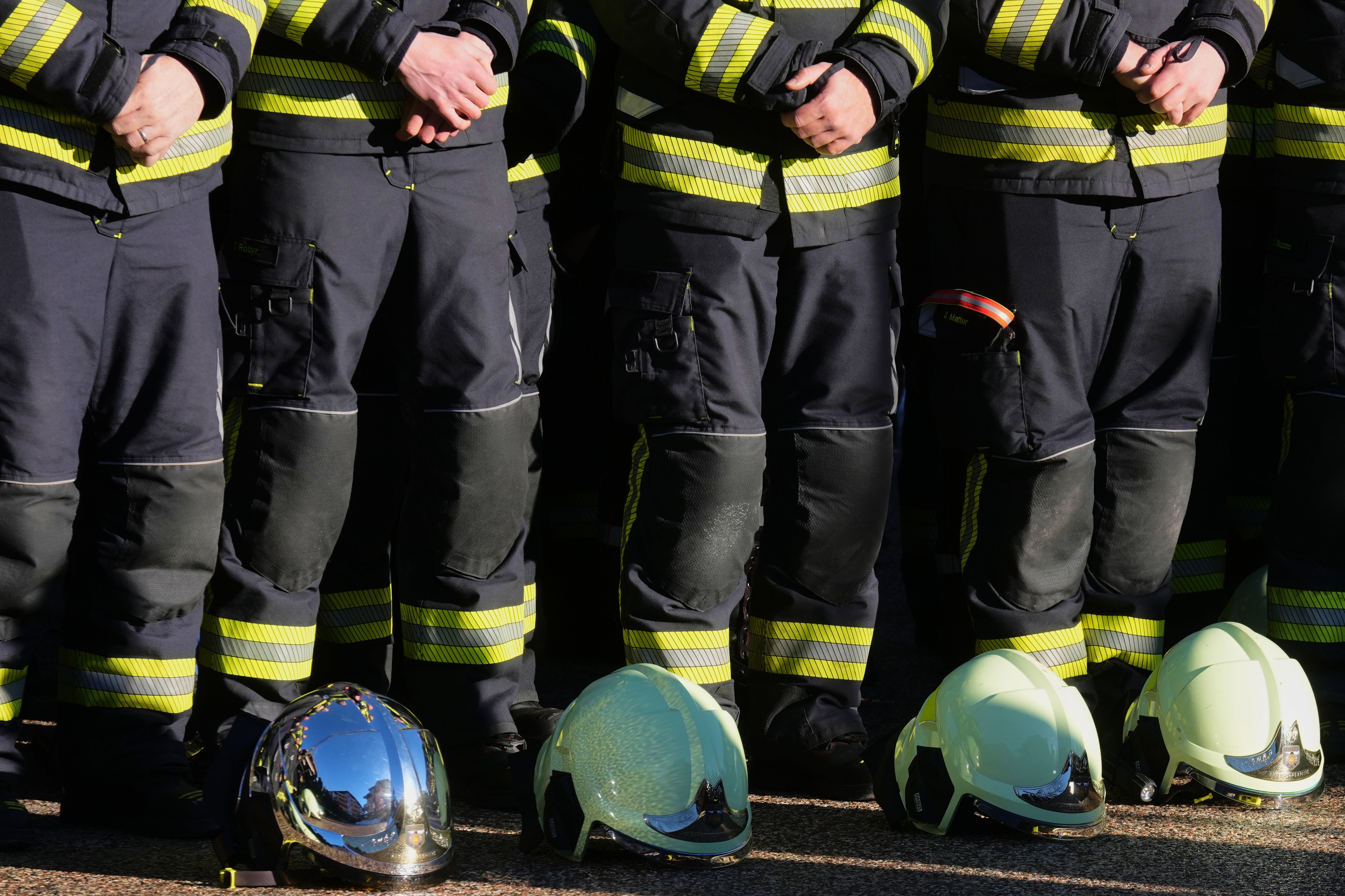 Firefighters stand outside the Chapelle St-Christophe during Sunday’s memorial mass in Crans-Montana