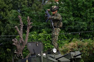 A Colombian soldier stands on top of a military vehicle at the border crossing with Venezuela in Cucuta, Colombia, on 3 January 2026