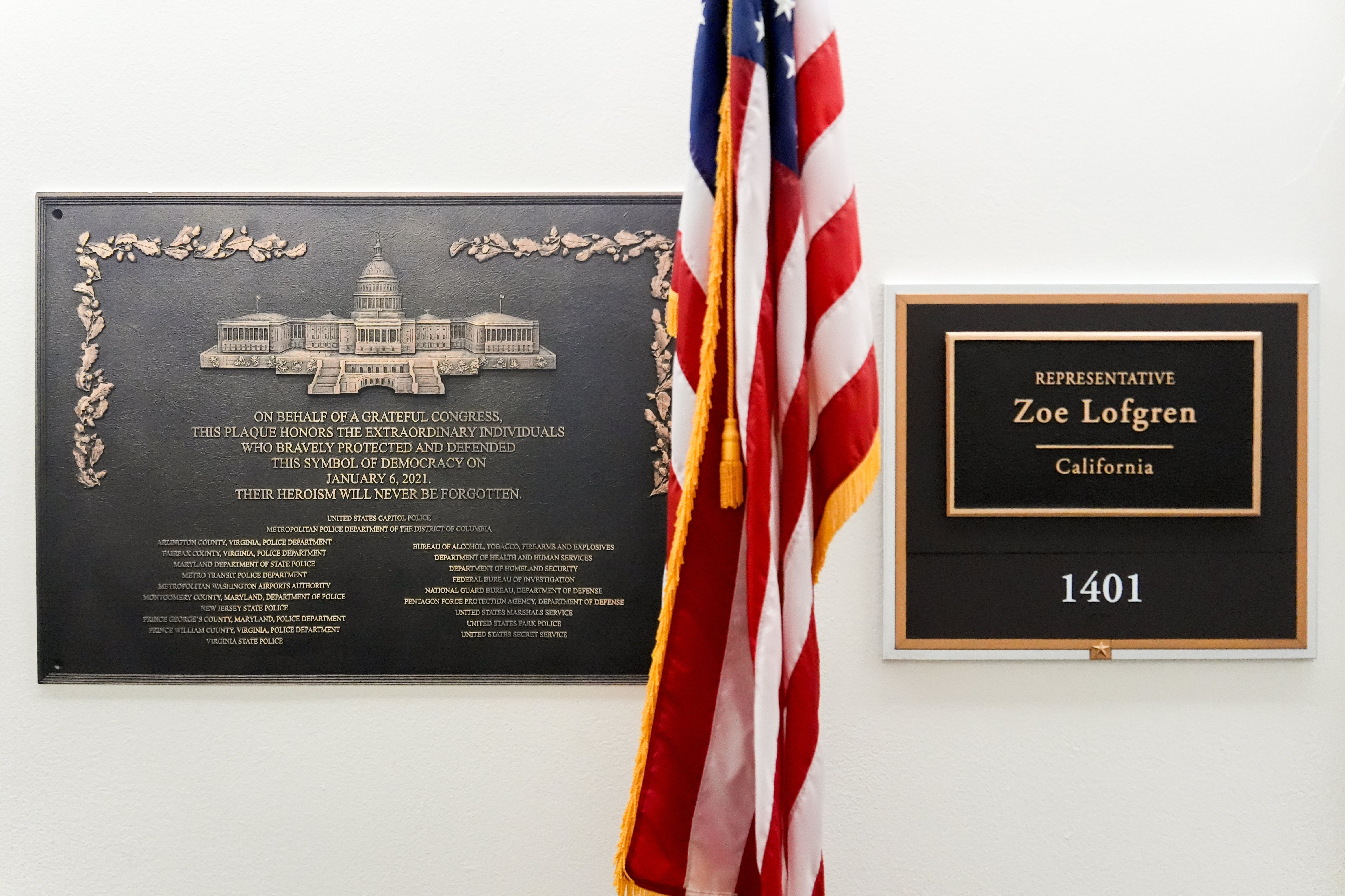 A replica plaque commemorating the Jan. 6, 2021 Capitol riot hangs outside the office of Rep. Zoe Lofgren