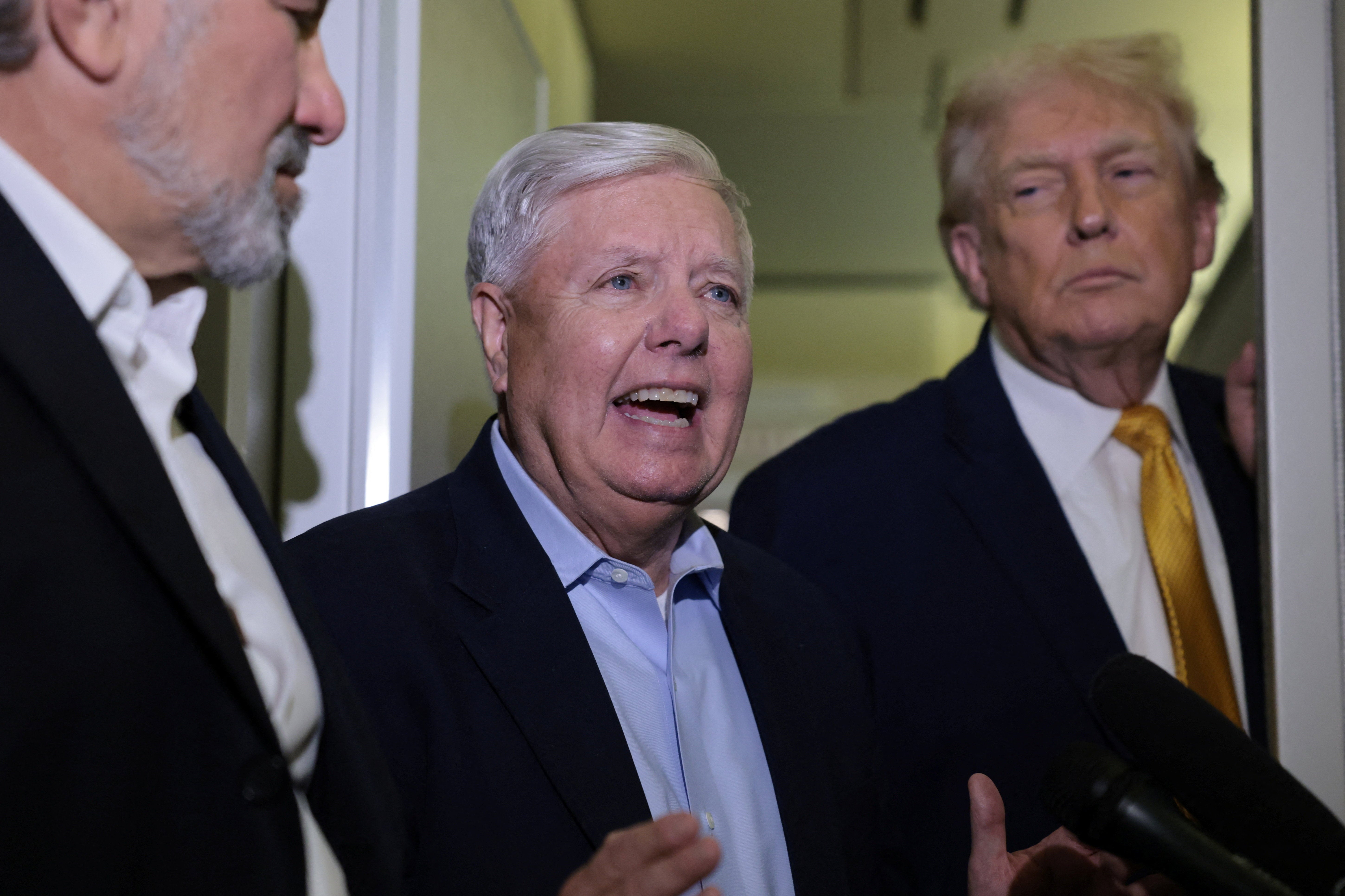 <p>Lindsey Graham speaks with reporters about Trump’s operation in Venezuela on board Air Force One</p>