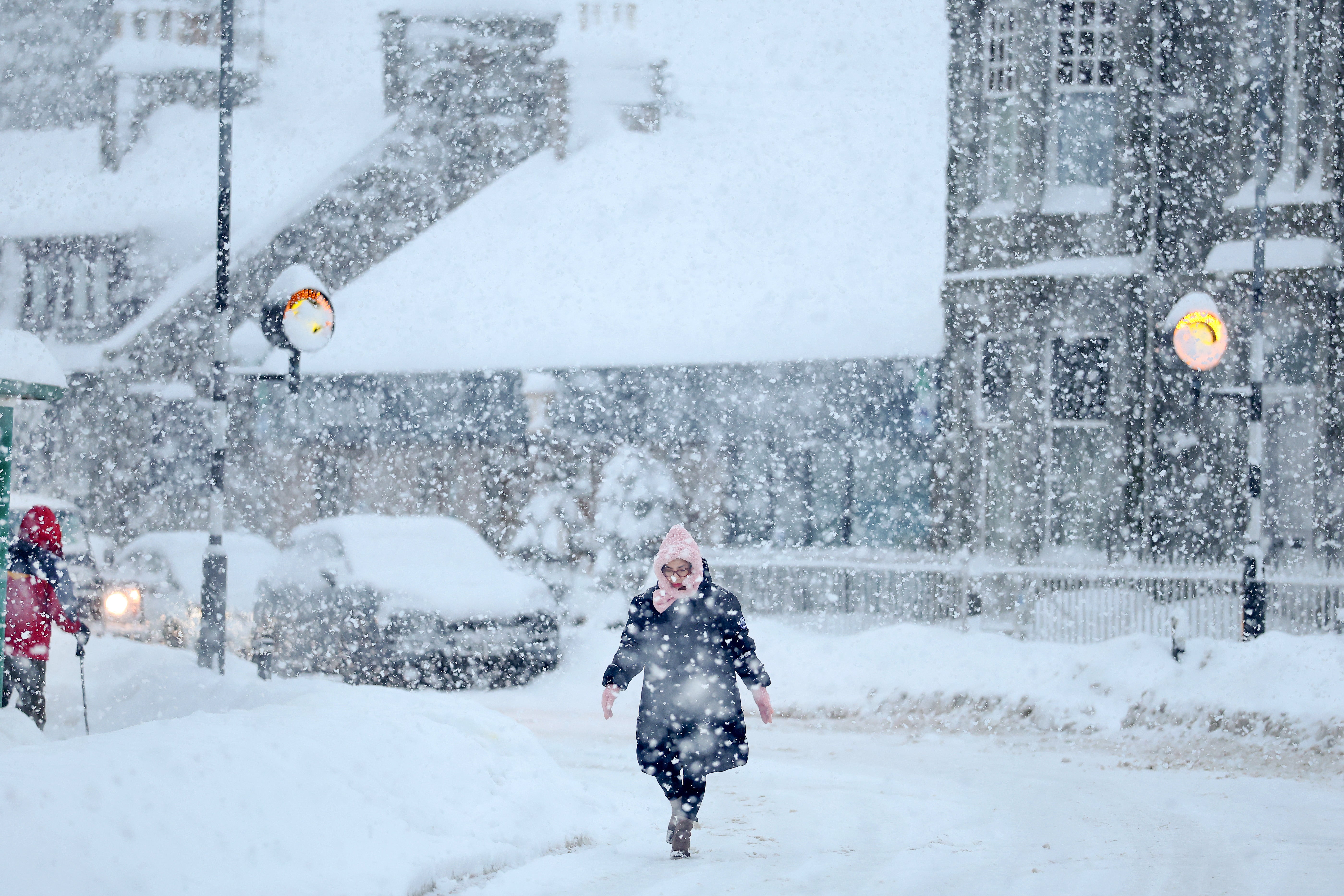 People walk in the snow, as Aberdeenshire Council declared a "major incident" as snow continues on January 06, 2026