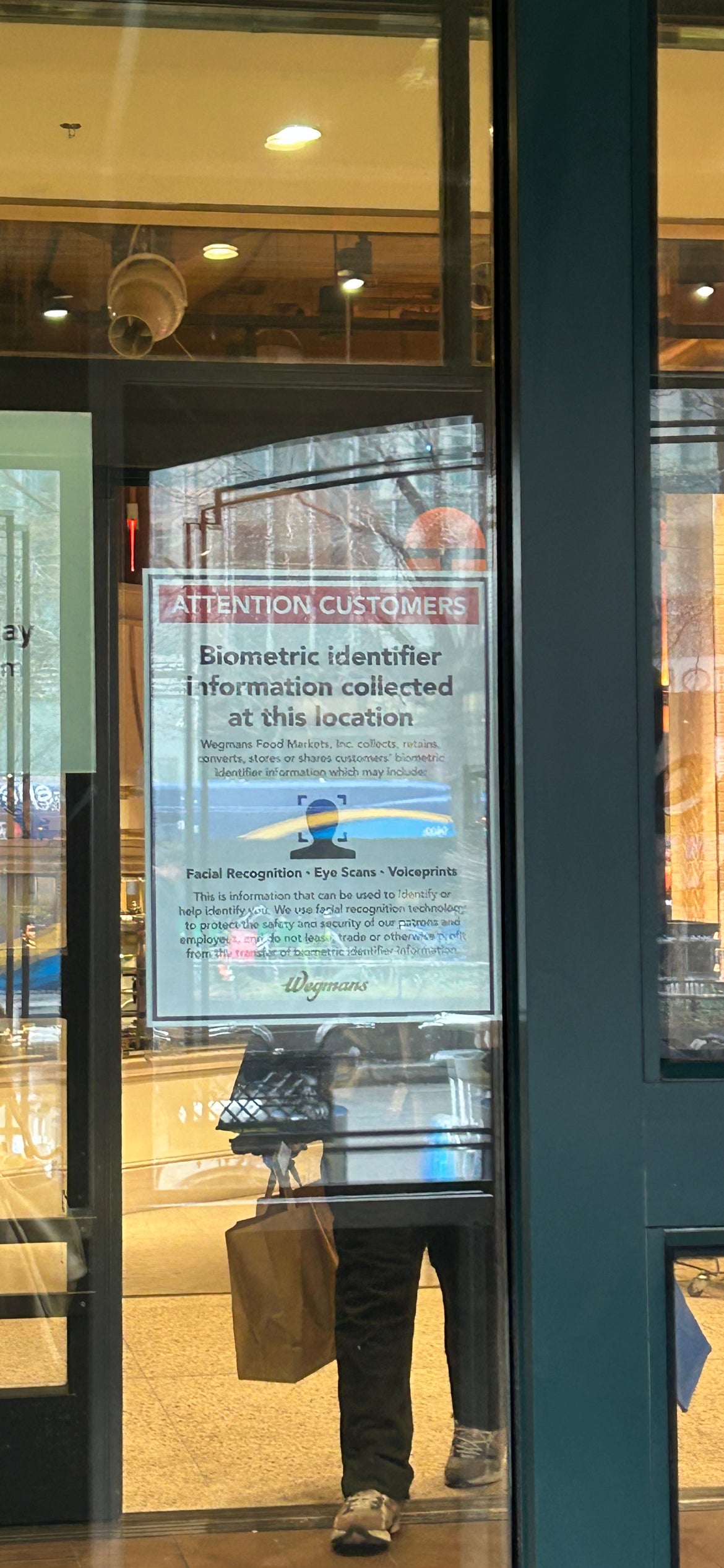 Signs outside the Manhattan Wegmans location entrance warn customers that facial recognition software is being used in the store