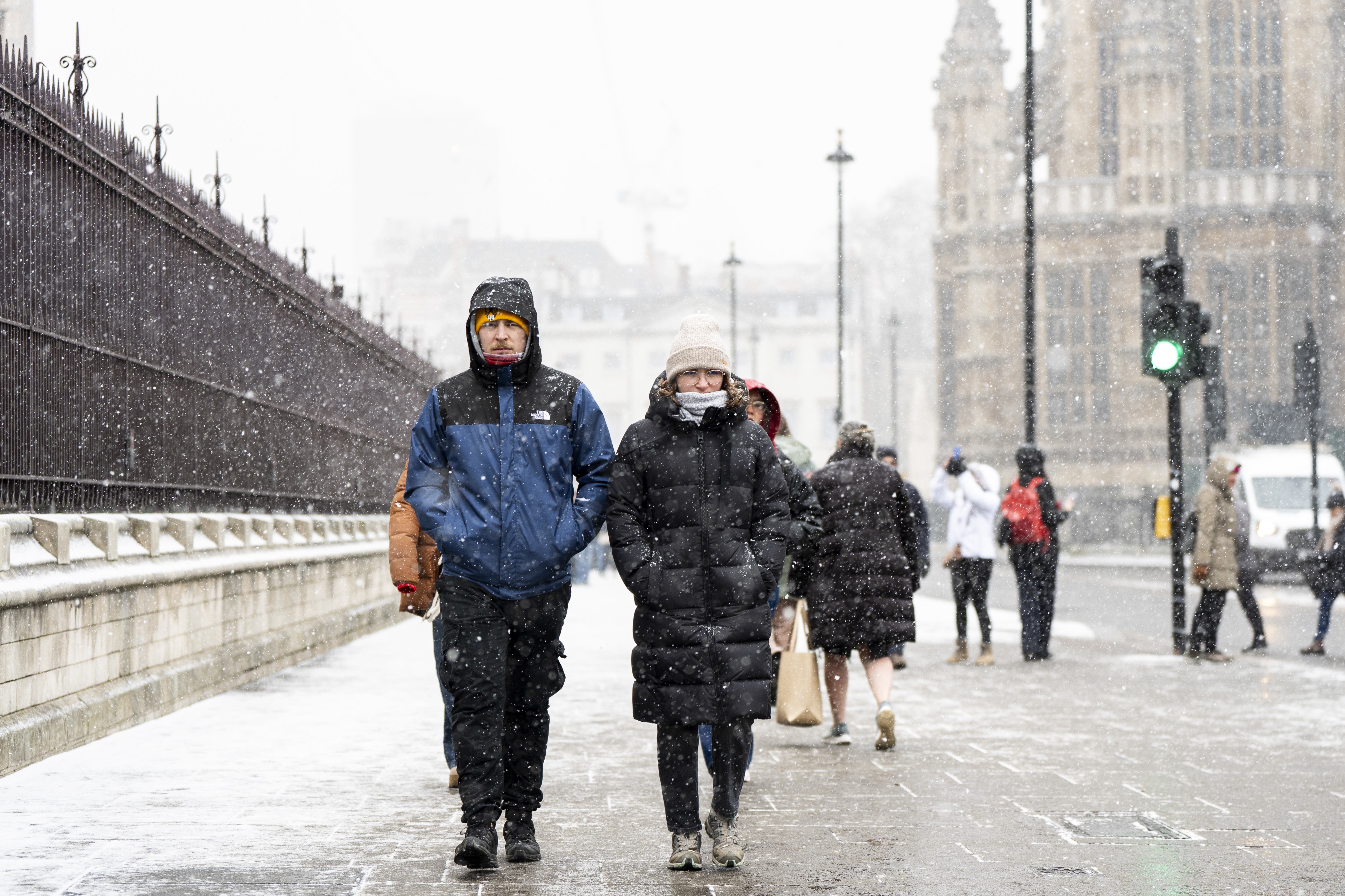 People in the snowy conditions in Westminster on Tuesday (Ben Whitley/PA)