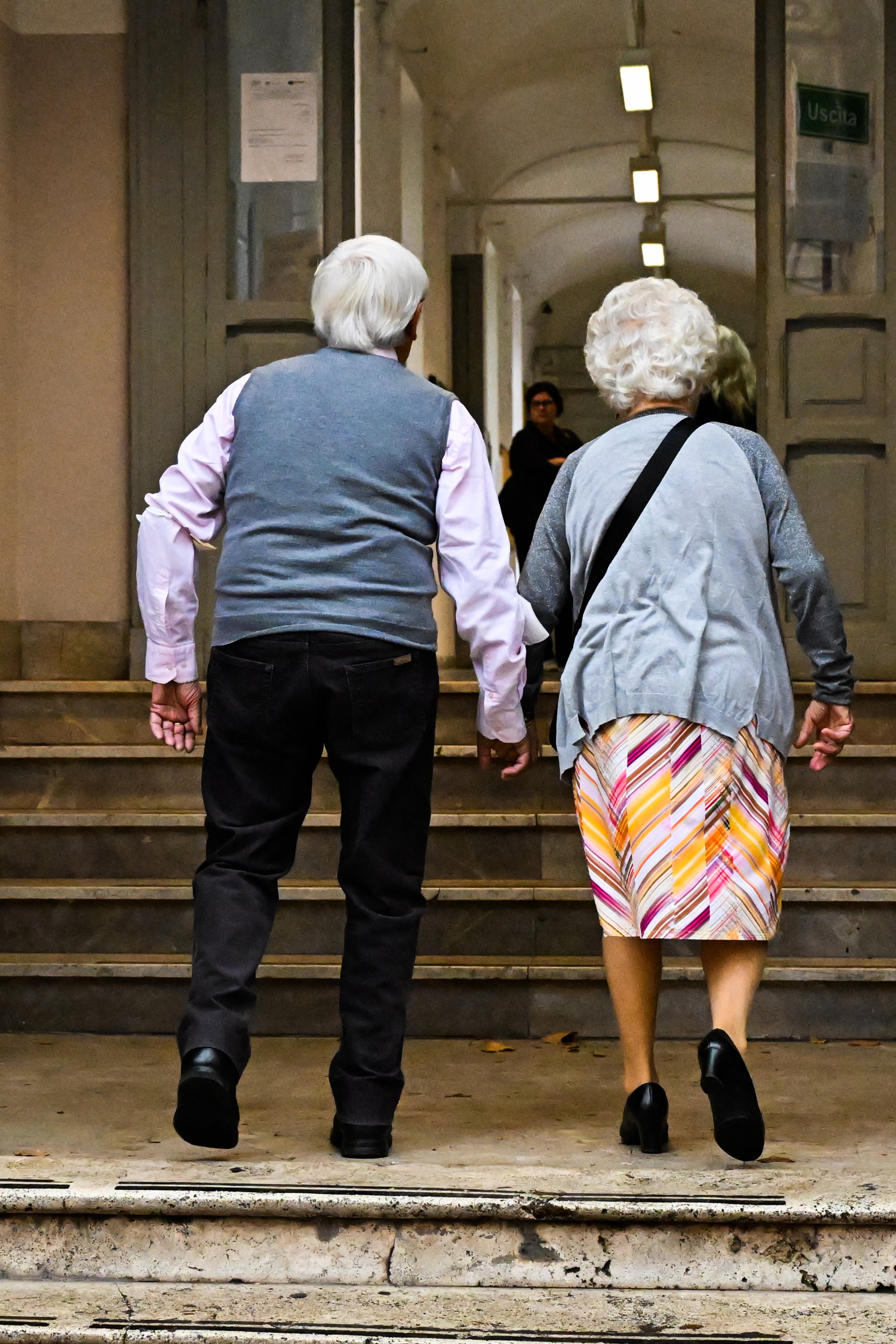 An elderly couple arrive to cast their vote in Rome