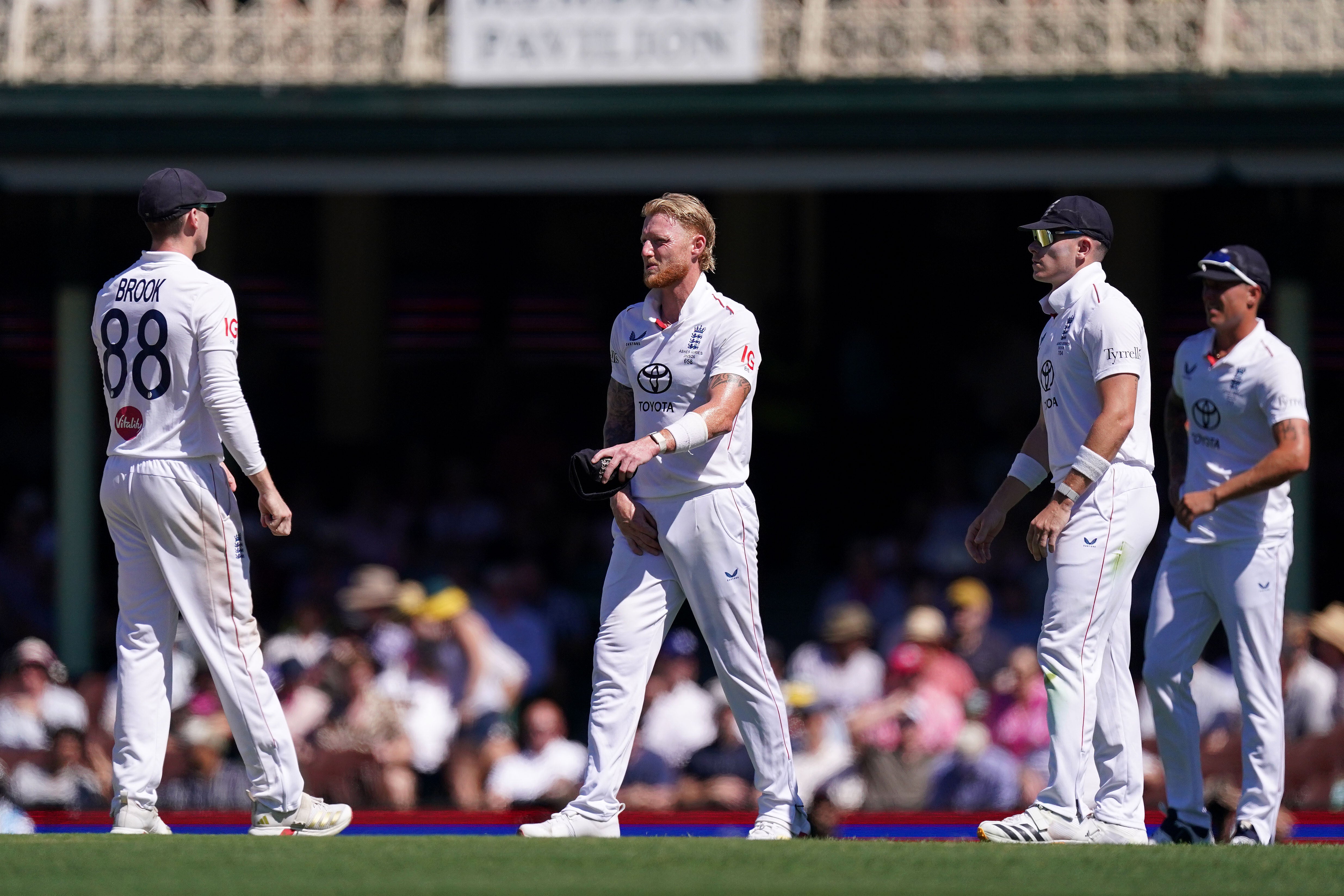 England captain Ben Stokes (centre) looks in pain and holds his groin after picking up an injury on day four of the fifth Test in Sydney (Robbie Stephenson/PA).