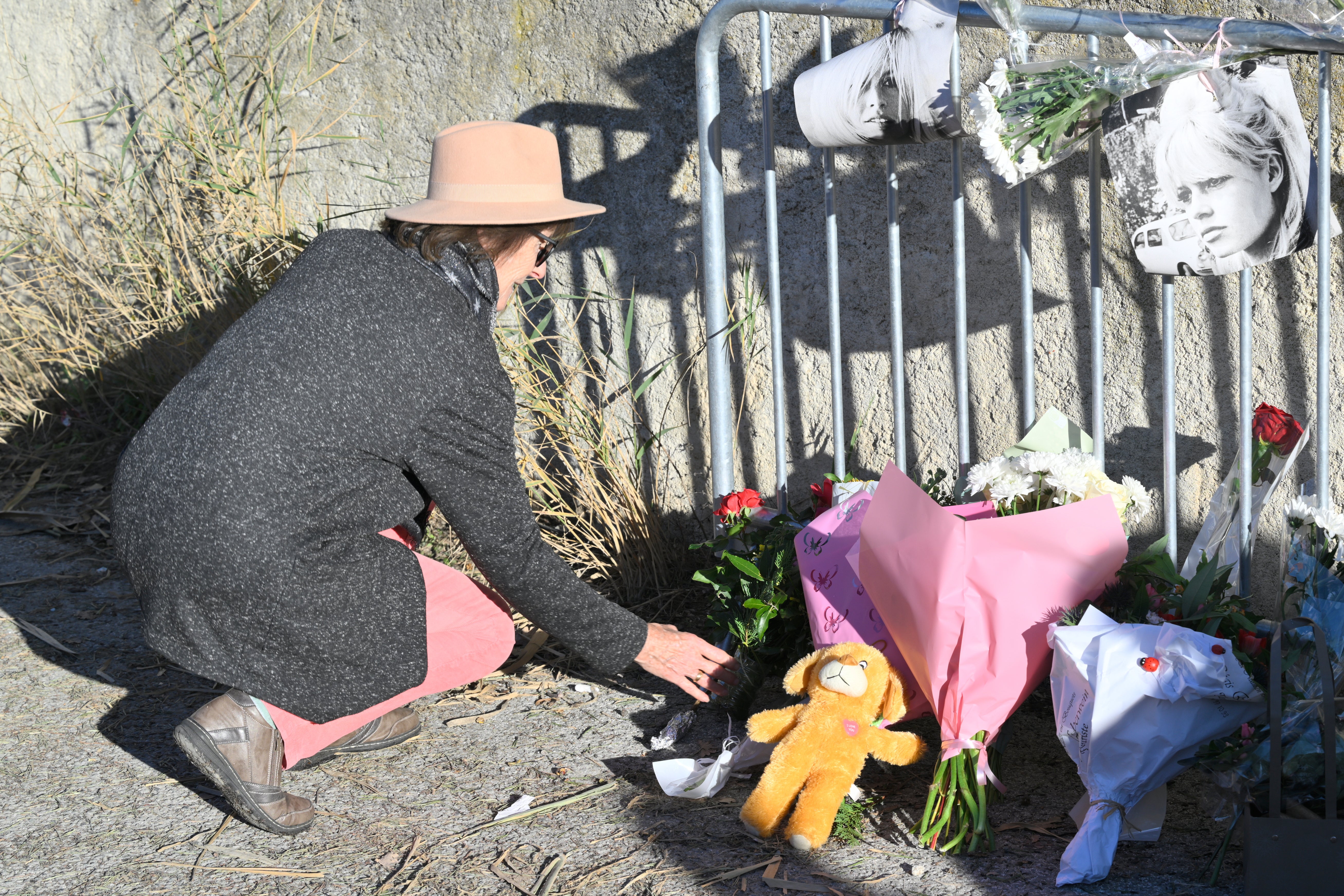 A woman lays flowers at actor Brigitte Bardot's home in Saint-Tropez