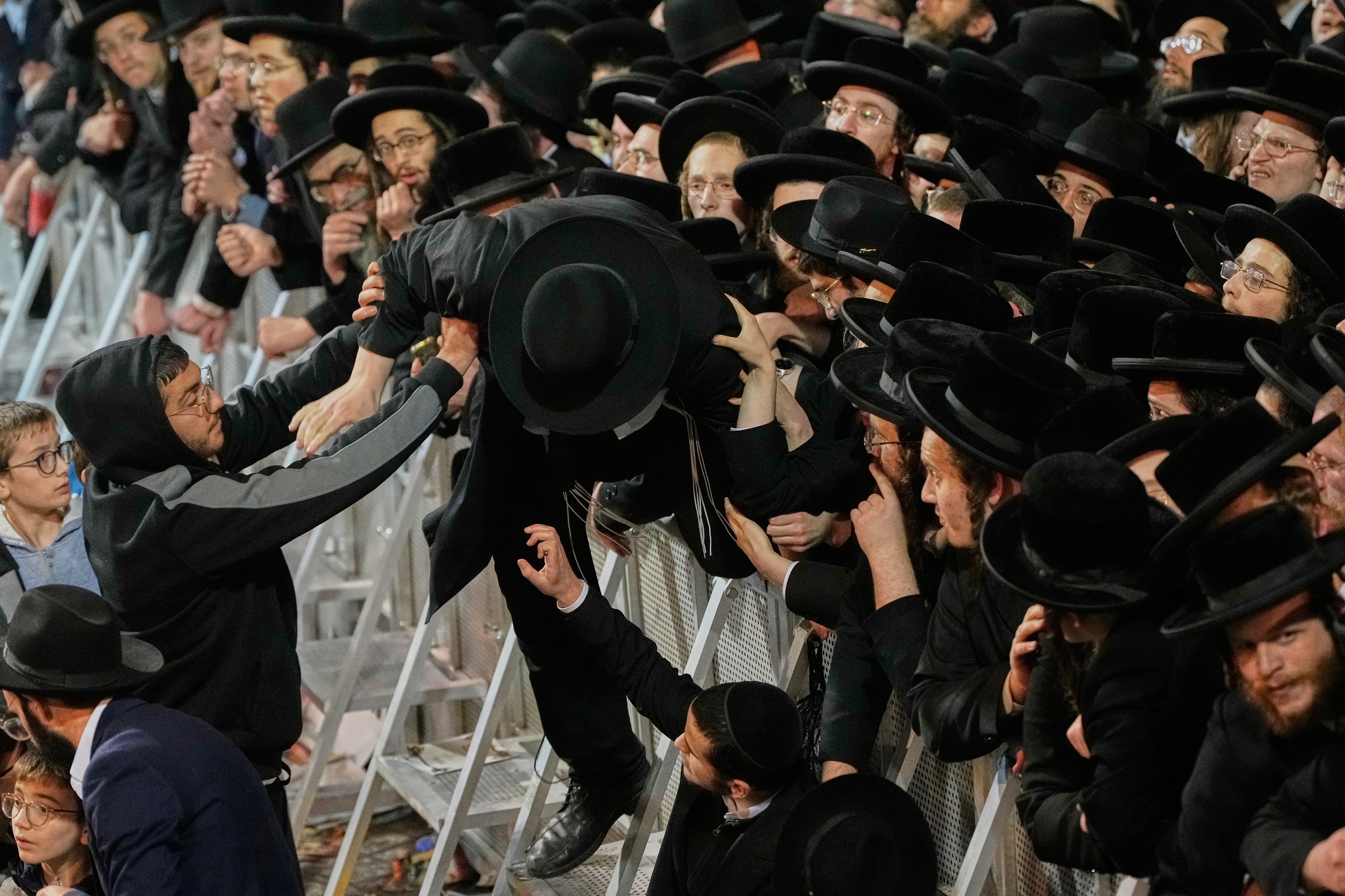 Ultra-Orthodox Jewish men protest against army recruitment in Jerusalem, Tuesday, Jan. 6, 2026. (AP Photo/Ohad Zwigenberg)