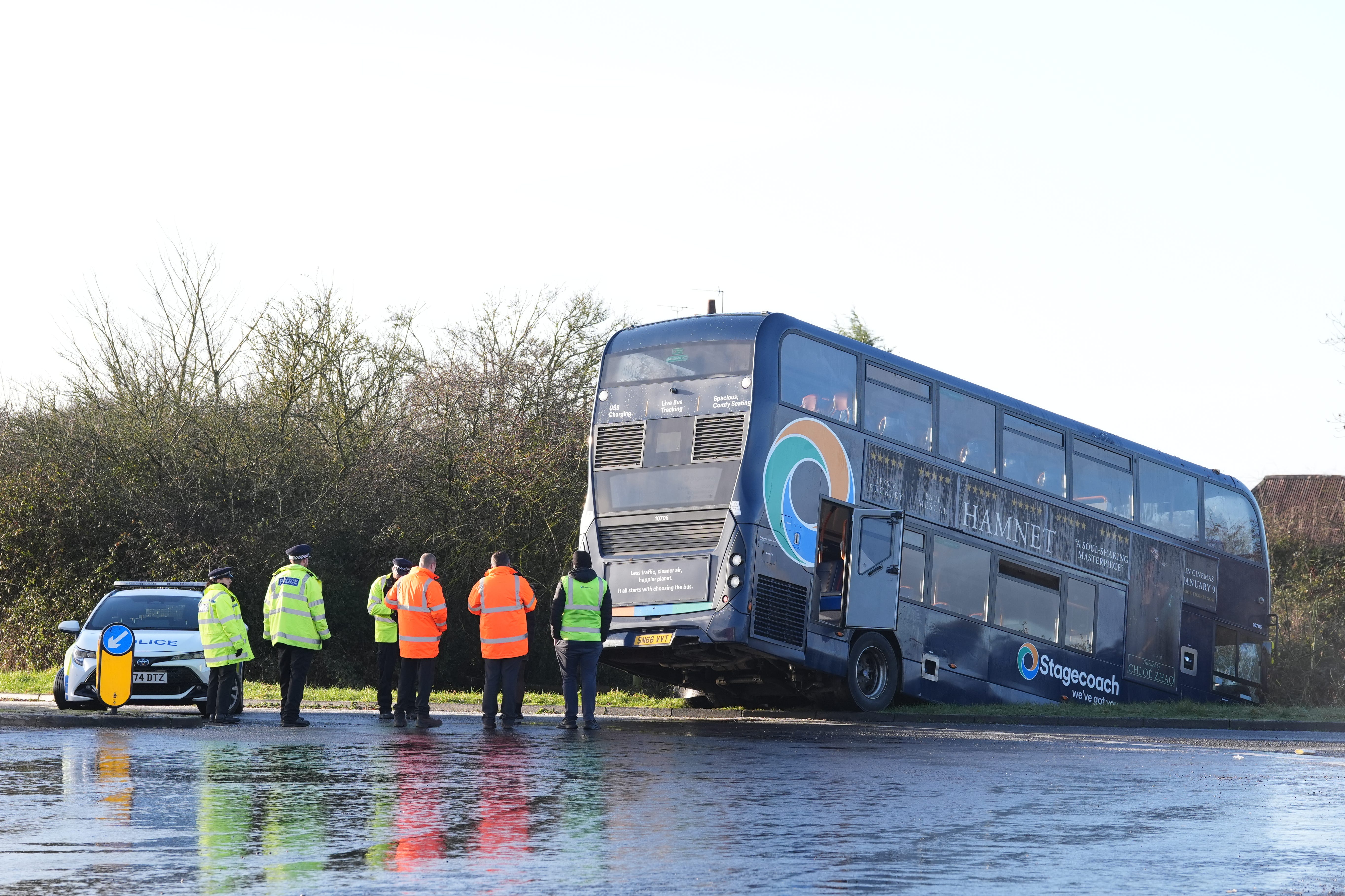 Police at the scene after a bus crashed into a ditch near Ashford in Kent (Gareth Fuller/PA)