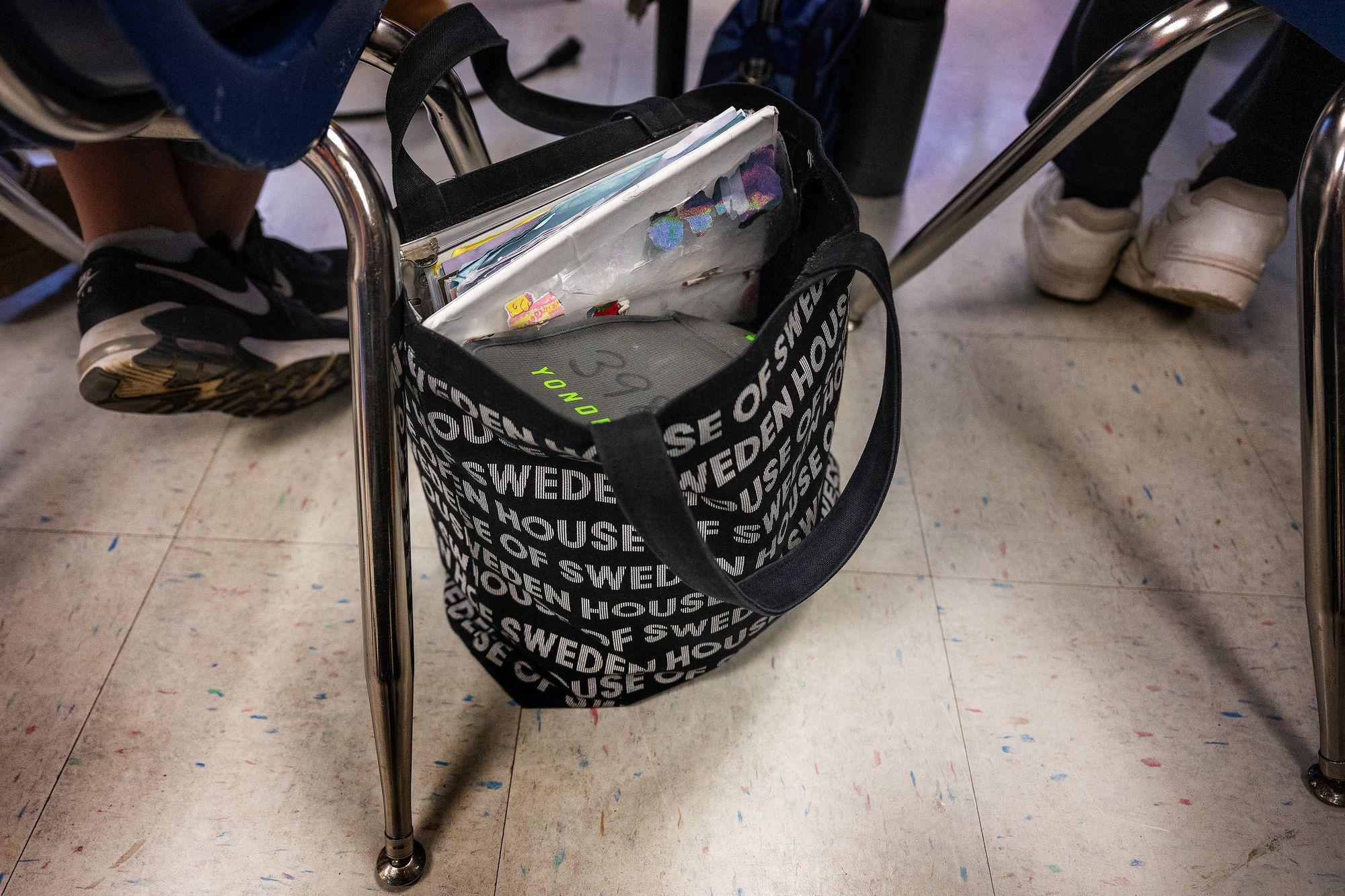 A YONDR locking pouch holds a Virginia student's phone in their bag. The bag can only be unlocked using a special magnetic tool