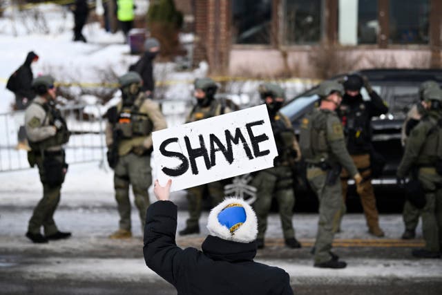 <p>An onlooker holds a sign that reads ‘Shame’ at the scene of a shooting by an ICE agent during federal law enforcement operations on January 7 in Minneapolis, Minnesota</p>