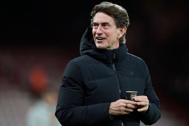 <p>Thomas Frank holding an Arsenal-branded coffee cup before kick-off at the Vitality Stadium</p>