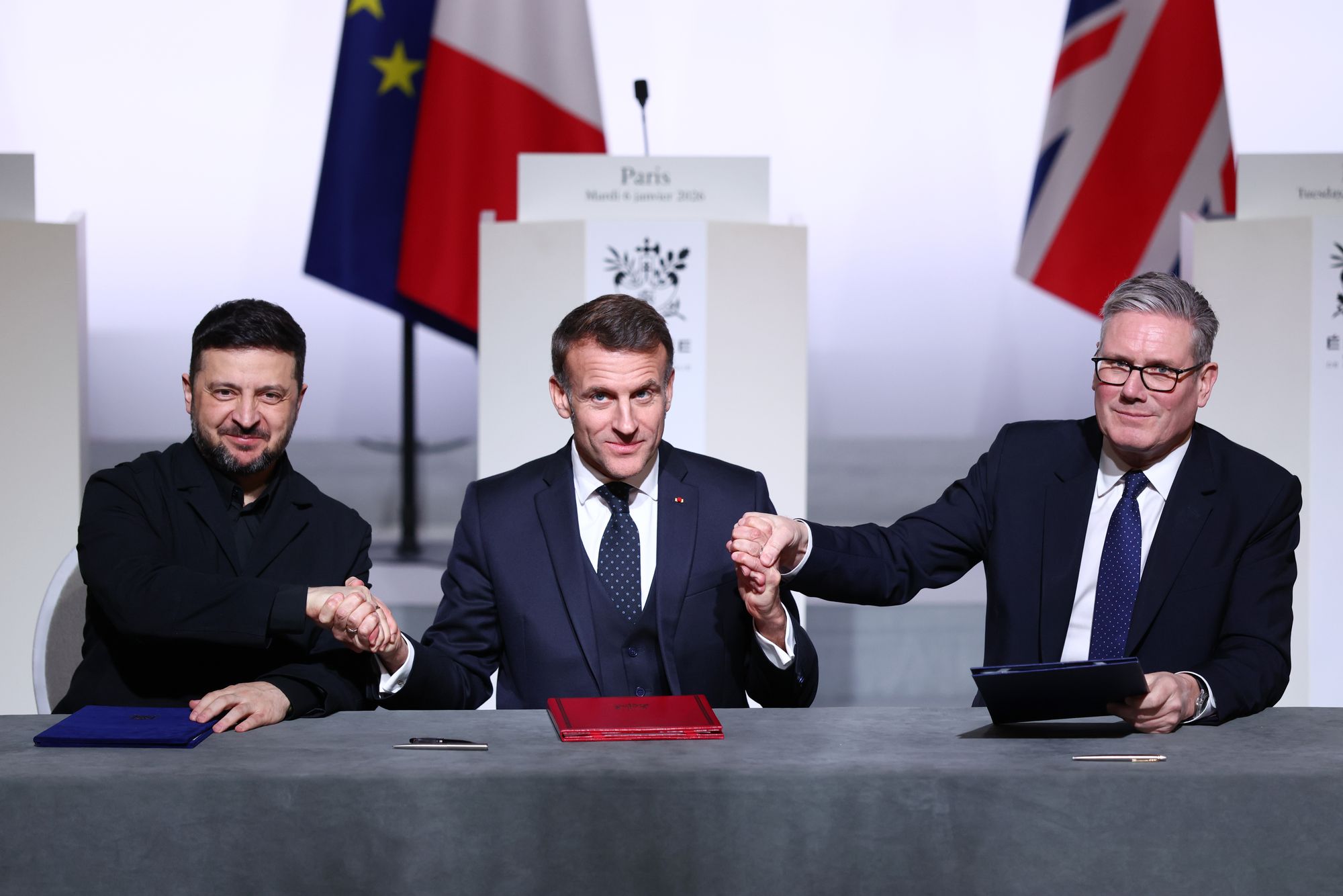 Volodymyr Zelensky, Emmanuel Macron and Keir Starmer sign the coalition of the willing deal in Paris