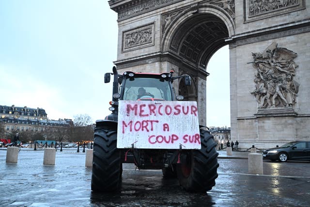 <p>A poster on a tractor reads 'Mercosur, death for sure' as farmers protest at the Arc de Triomphe against the Mercosur trade alliance with South America countries but also against EU farming policy or mass cull of cows ordered to contain the spread of a skin disease, Thursday, Jan. 8, 2026 in Paris.</p>