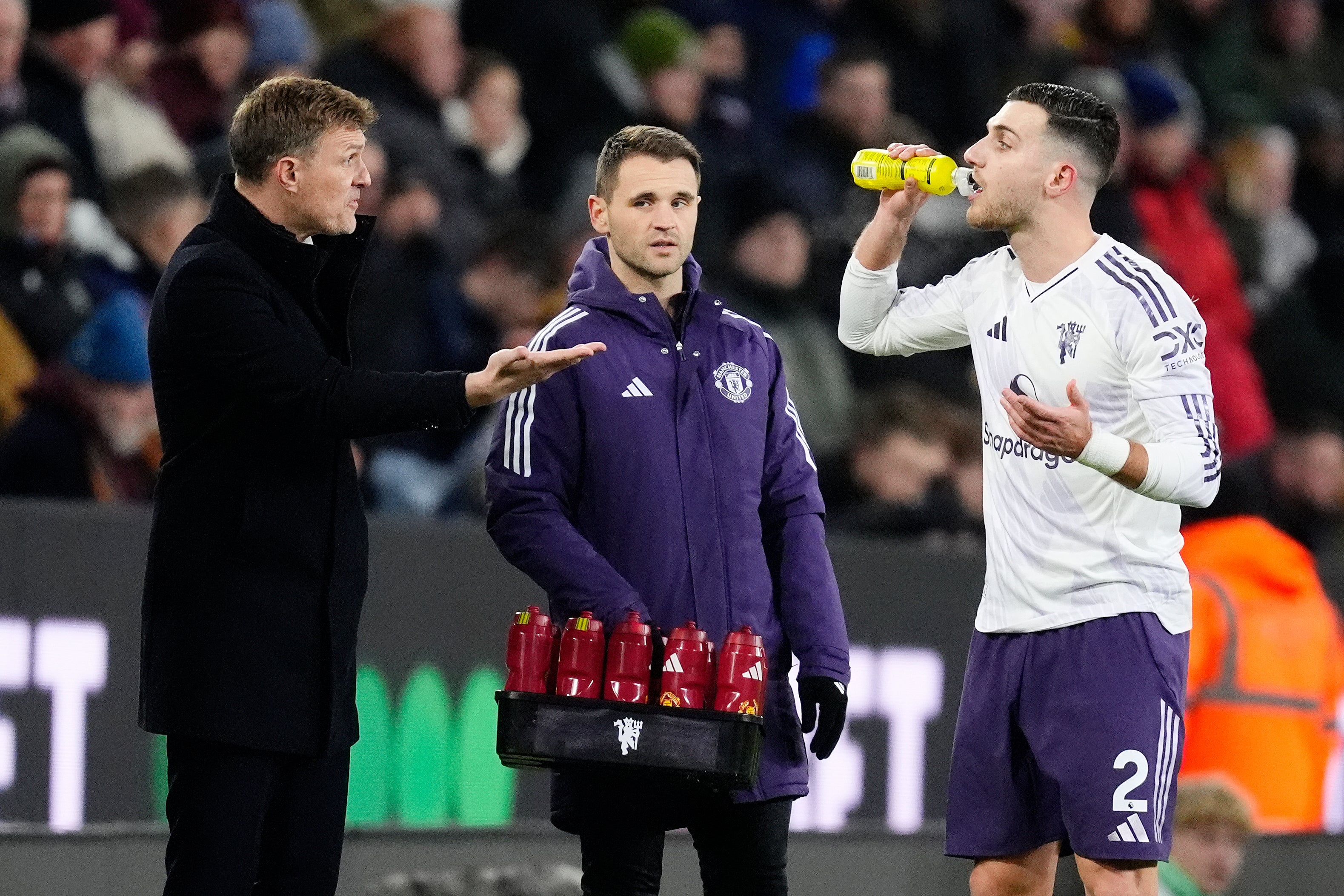 Manchester United interim head coach Darren Fletcher (left) and Diogo Dalot speak on the touchline