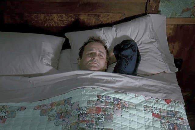 <p>Bill Murray lays in his bed in the 1993 film Groundhog Day. Staying in bed for extended periods of time has become a Gen Z trend that experts warn could be dangerous for your health.</p>
