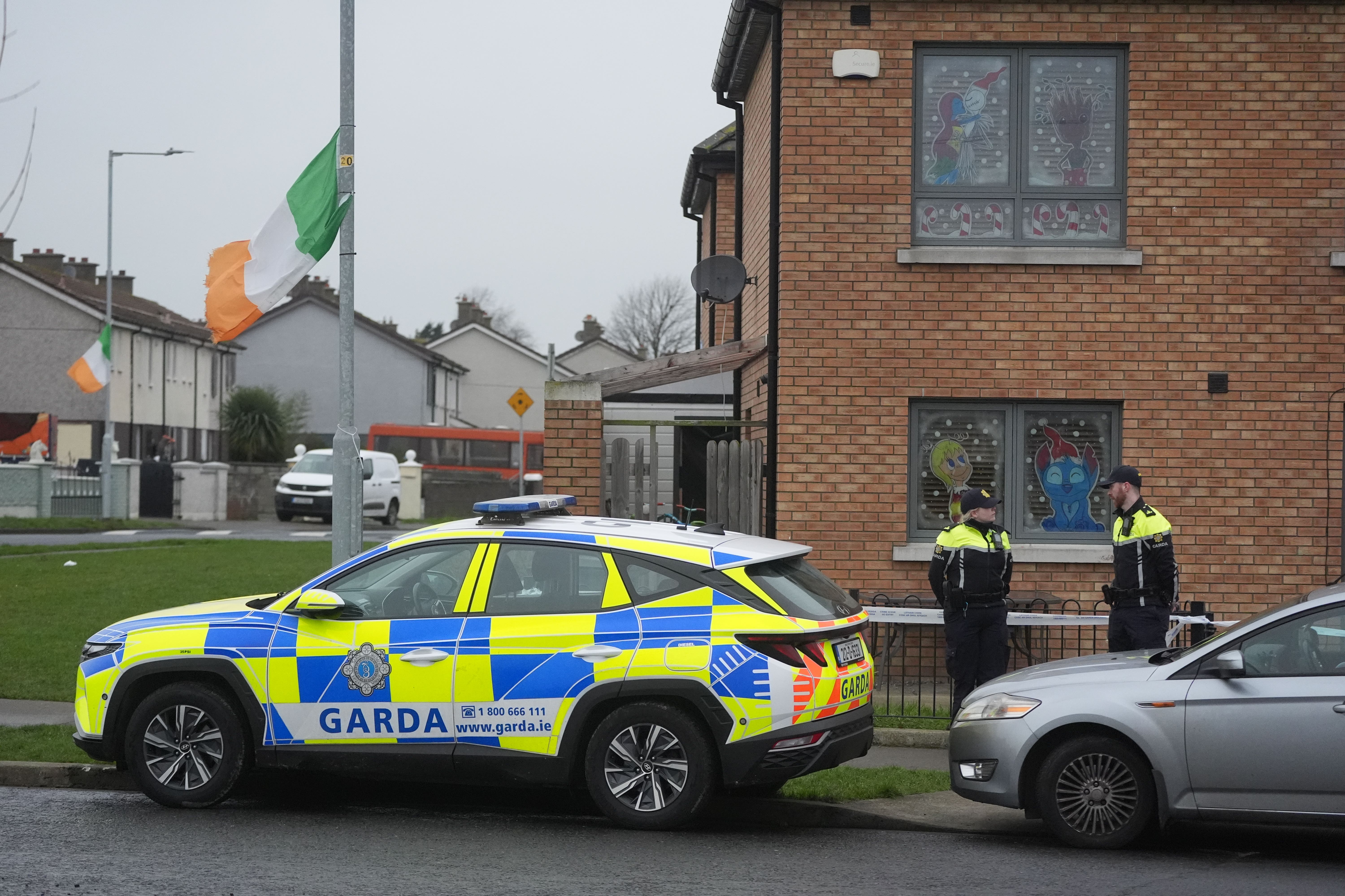Members of An Garda outside a property in the Cherry Orchard area of Ballyfermot, west Dublin (Brian Lawless/PA)