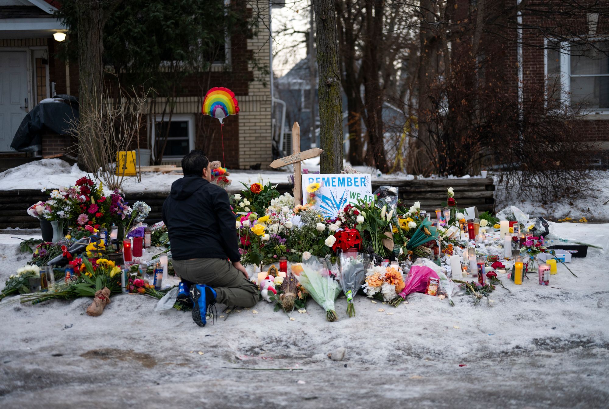 A man kneels at a memorial for Renee Nicole Good near where she was killed. The Trump administration has aggressively defended the ICE agent’s actions.