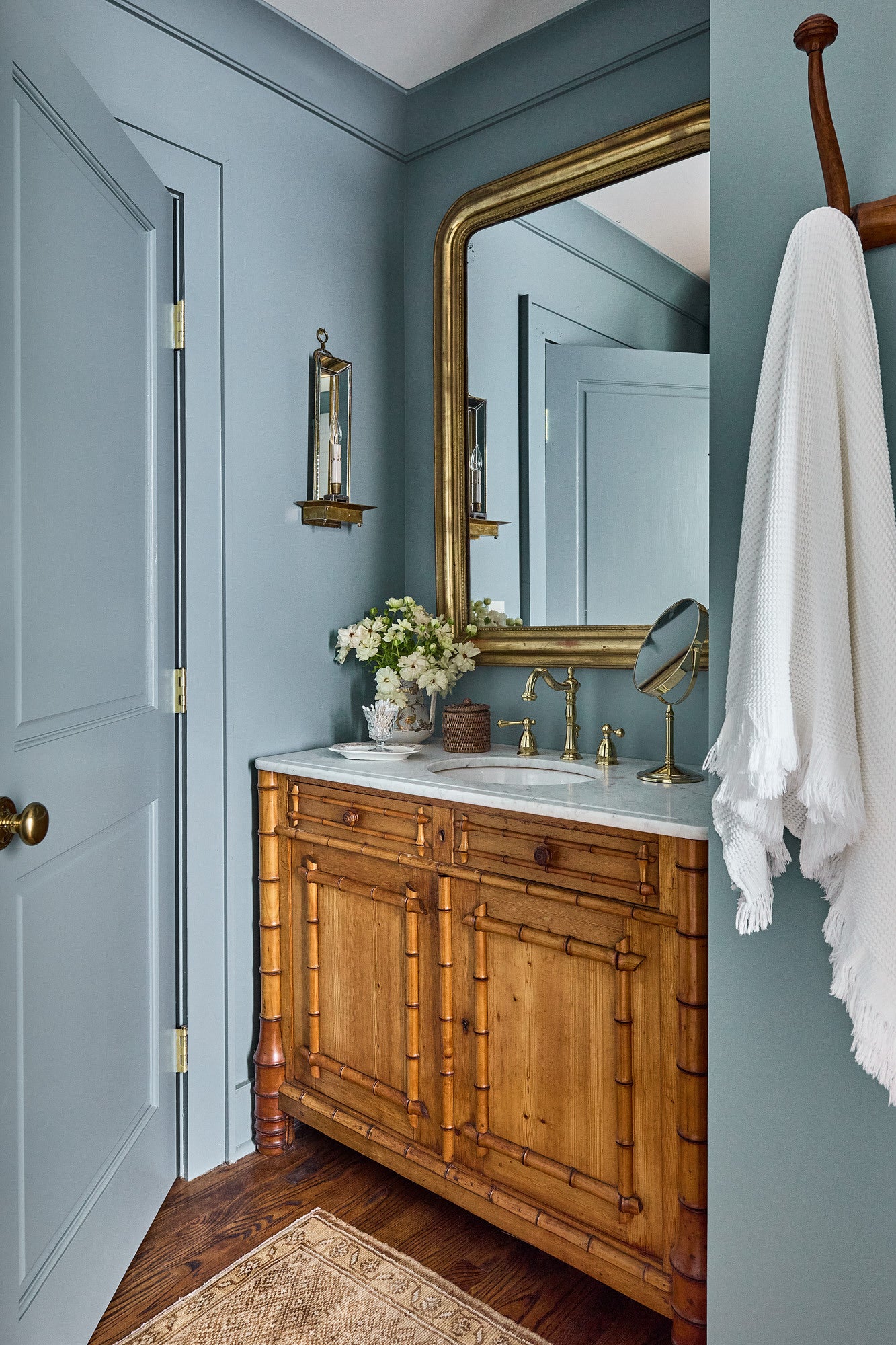 A French bamboo cabinet repurposed for a bathroom vanity, appears in the home of interior design and antiques dealer Debbie Matthews Leroy, in Linville, N.C.