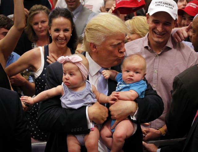<p>Trump, pictured kissing a baby in 2016, has consistently pushed forward policies that the administration believes will encourage people to have more children</p>